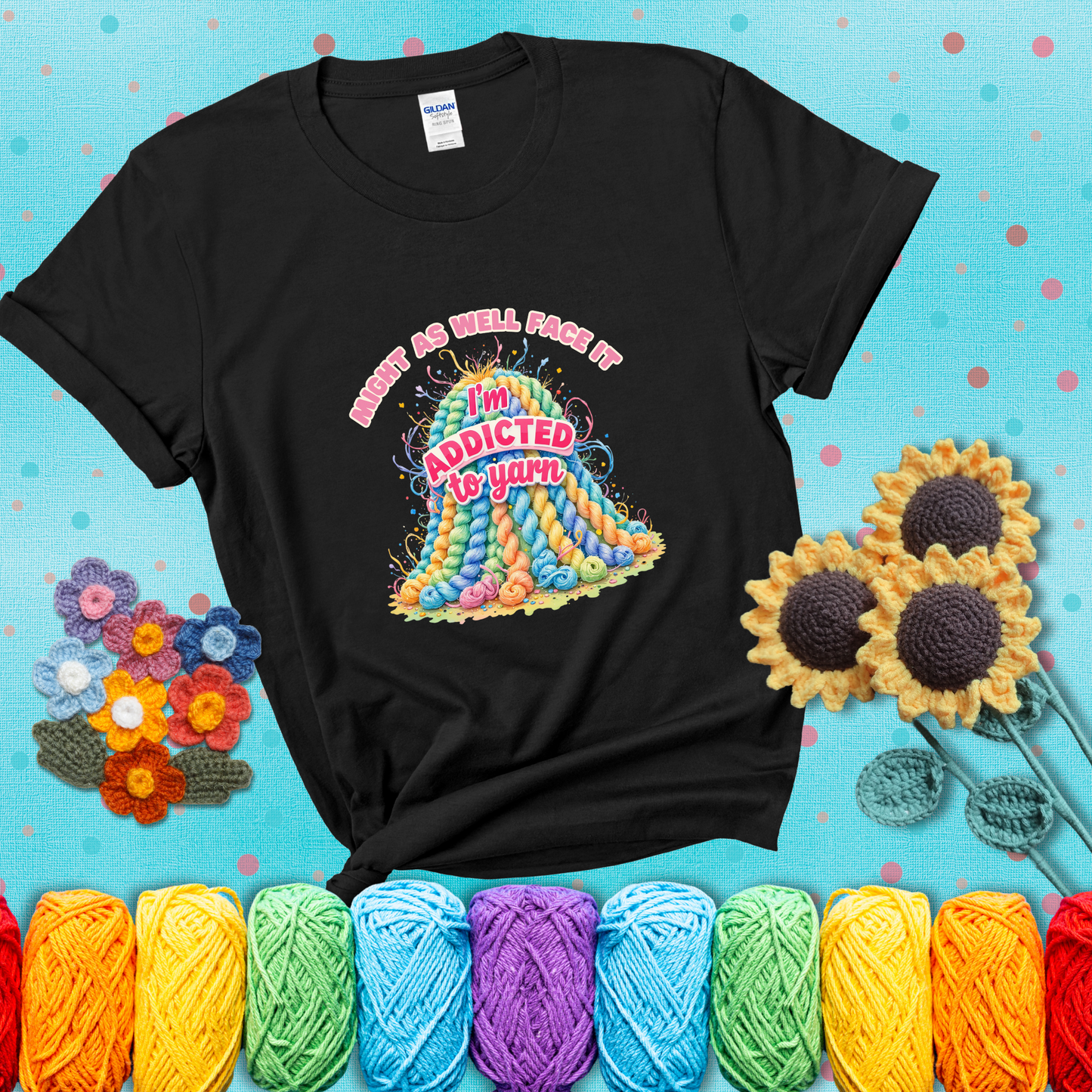 Colorful mountain of pastel yarn hanks with the phrase “Might as well face it, I’m addicted to yarn” in playful pink and red lettering showing a black tee with a teal sunflower background
