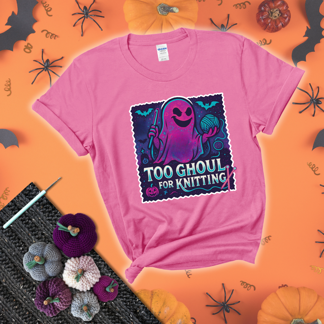 A spooky ghost holds a yarn ball and crochet hook in a vibrant Halloween palette with bats, tombstones, and pumpkins wearing a pink tee with a festive halloween background
