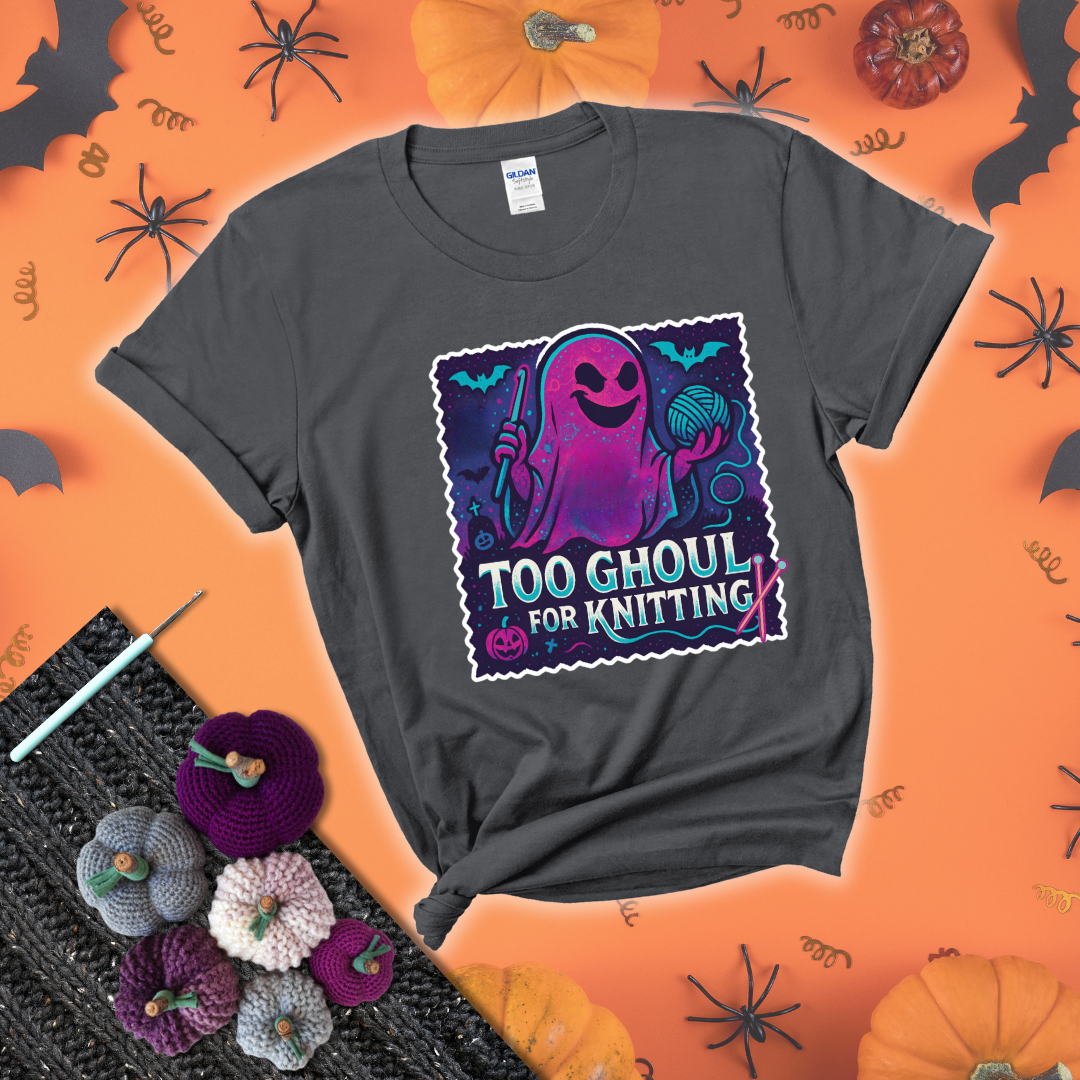 A spooky ghost holds a yarn ball and crochet hook in a vibrant Halloween palette with bats, tombstones, and pumpkins wearing a dark grey tee with a festive halloween background