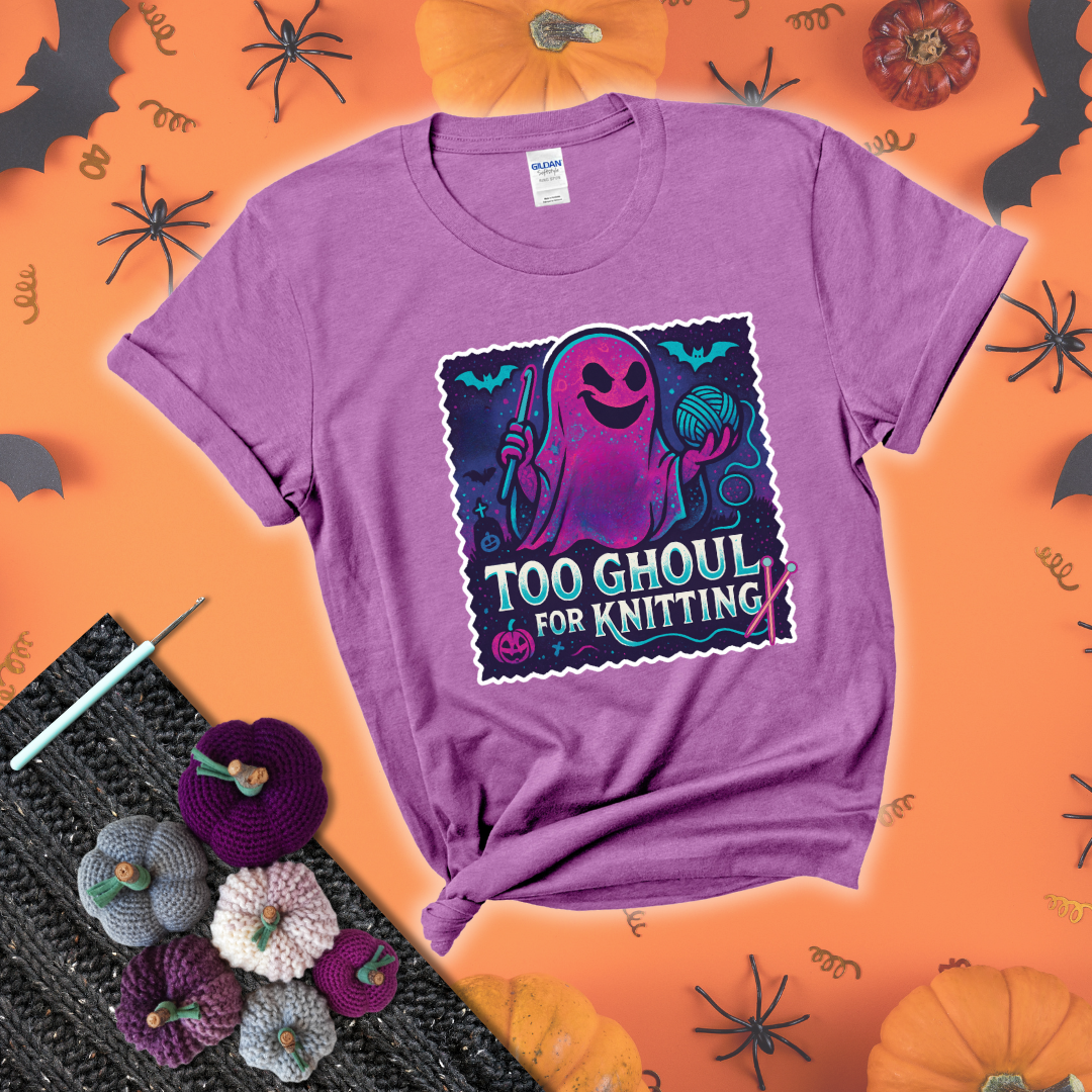 A spooky ghost holds a yarn ball and crochet hook in a vibrant Halloween palette with bats, tombstones, and pumpkins wearing a light purple tee with a festive halloween background