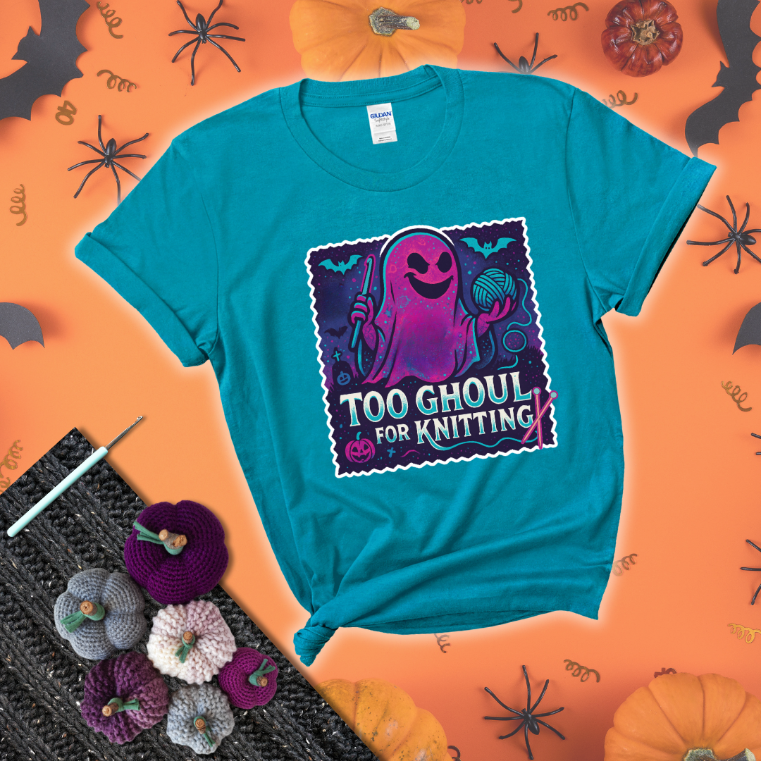 A spooky ghost holds a yarn ball and crochet hook in a vibrant Halloween palette with bats, tombstones, and pumpkins wearing a blue-green tee with a festive halloween background
