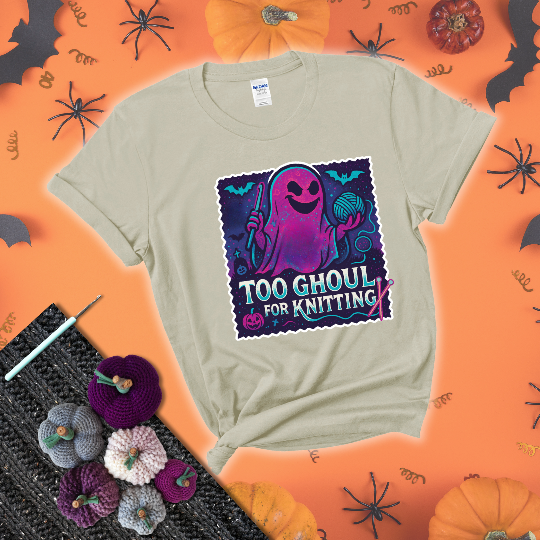 A spooky ghost holds a yarn ball and crochet hook in a vibrant Halloween palette with bats, tombstones, and pumpkins wearing a beige tee with a festive halloween background