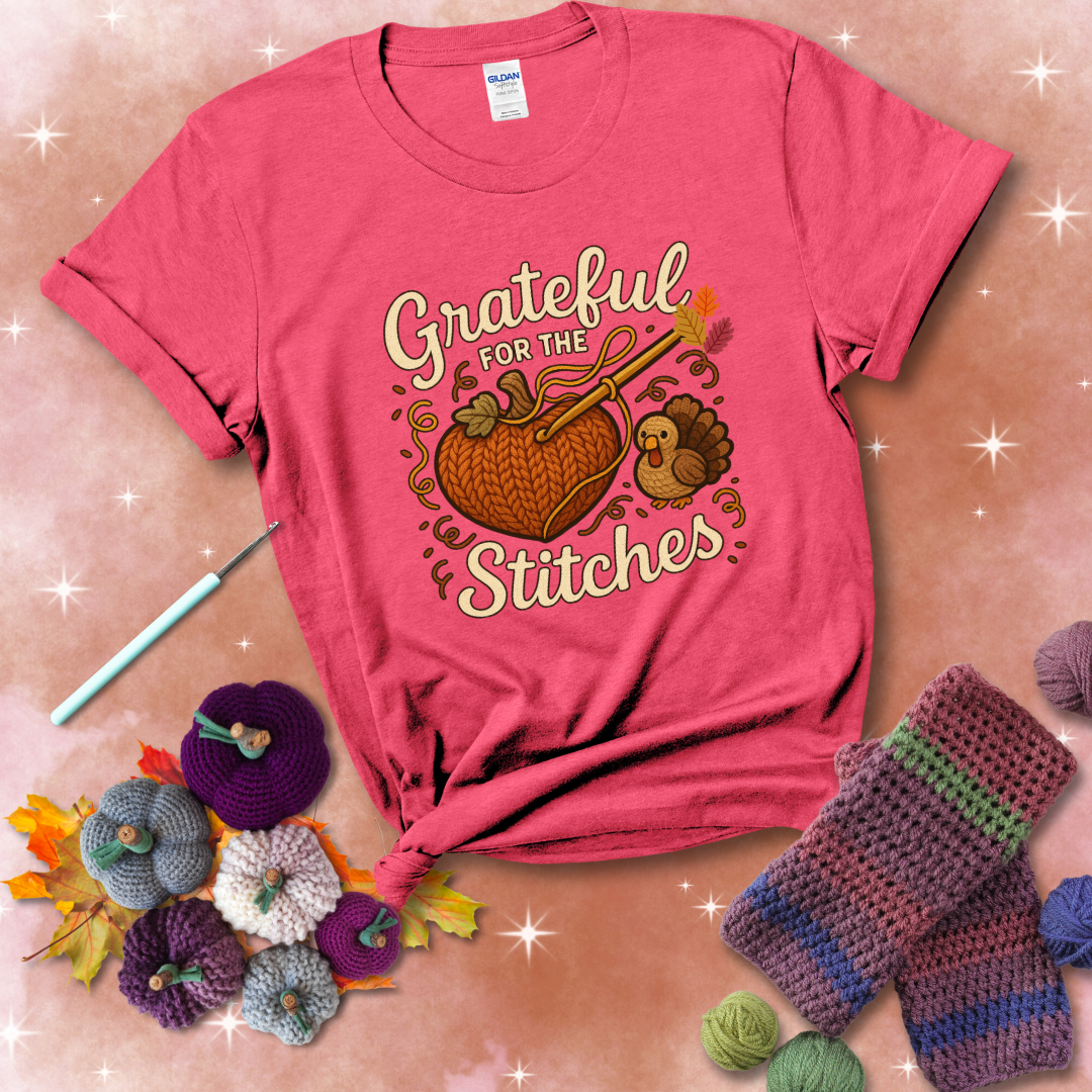 A cozy fall scene with a crochet hook stitching a heart-shaped pumpkin, surrounded by yarn and a small turkey, showing a light red tee with a festive Fall background