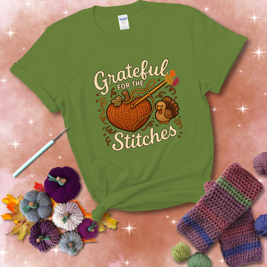 A cozy fall scene with a crochet hook stitching a heart-shaped pumpkin, surrounded by yarn and a small turkey, showing a bright green tee with a festive Fall background