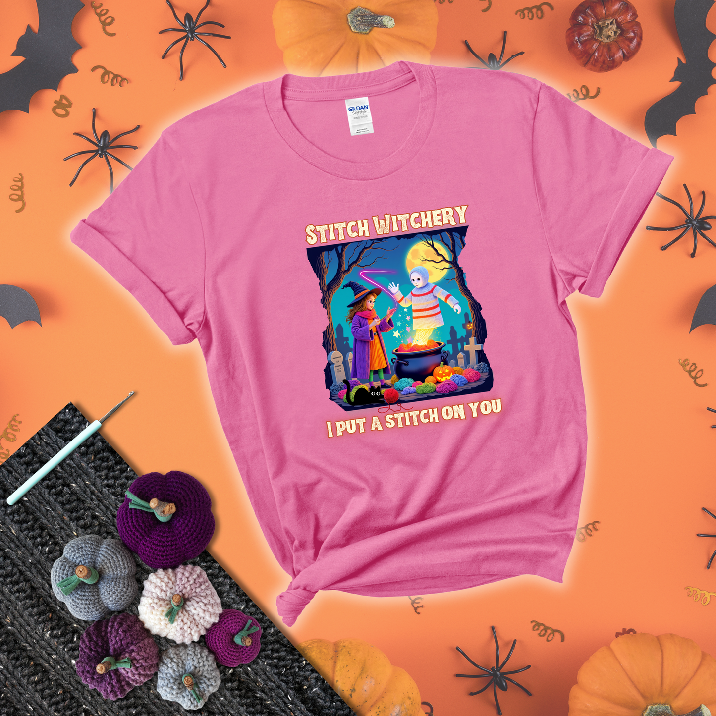 A Halloween scene with a young witch casting a yarn spell from a cauldron onto a floating crochet-ghost figure, under the phrase “I Put a Stitch on You” showing a pink tee with a festive Halloween background