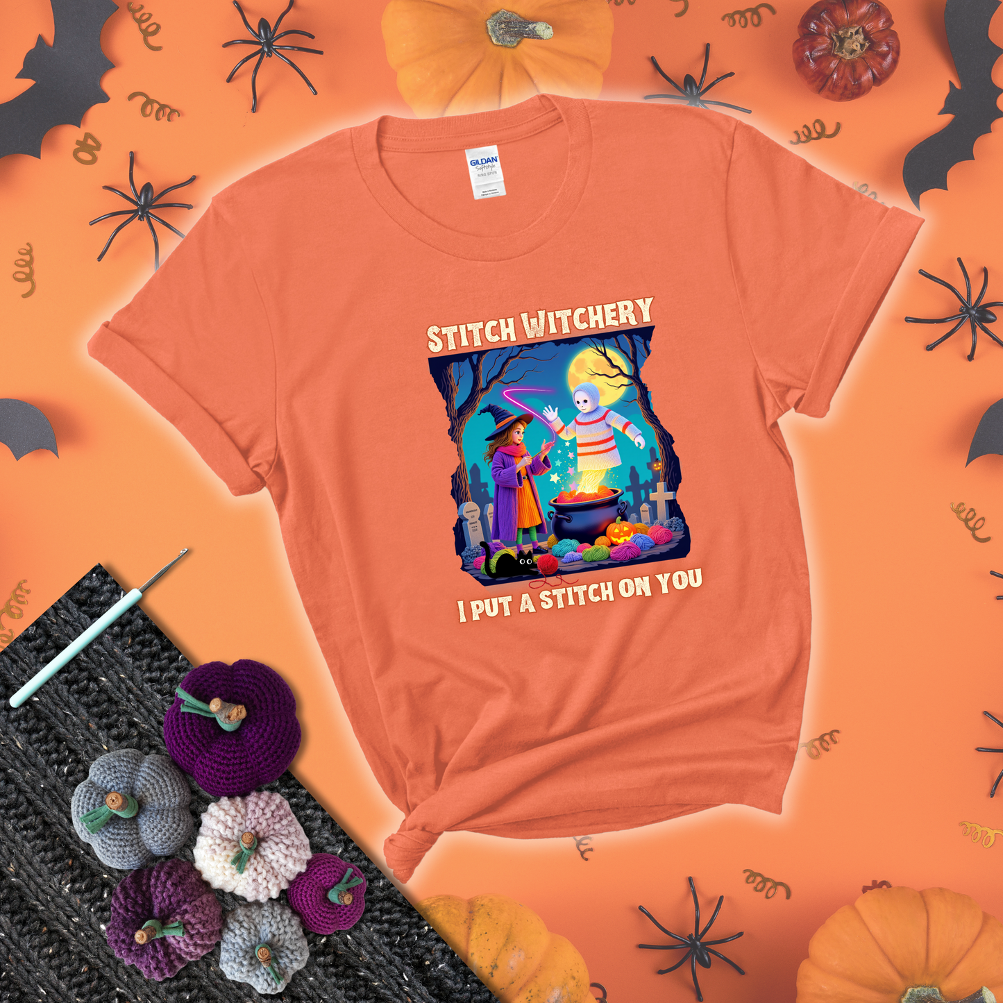 A Halloween scene with a young witch casting a yarn spell from a cauldron onto a floating crochet-ghost figure, under the phrase “I Put a Stitch on You” showing a light orange tee with a festive Halloween background