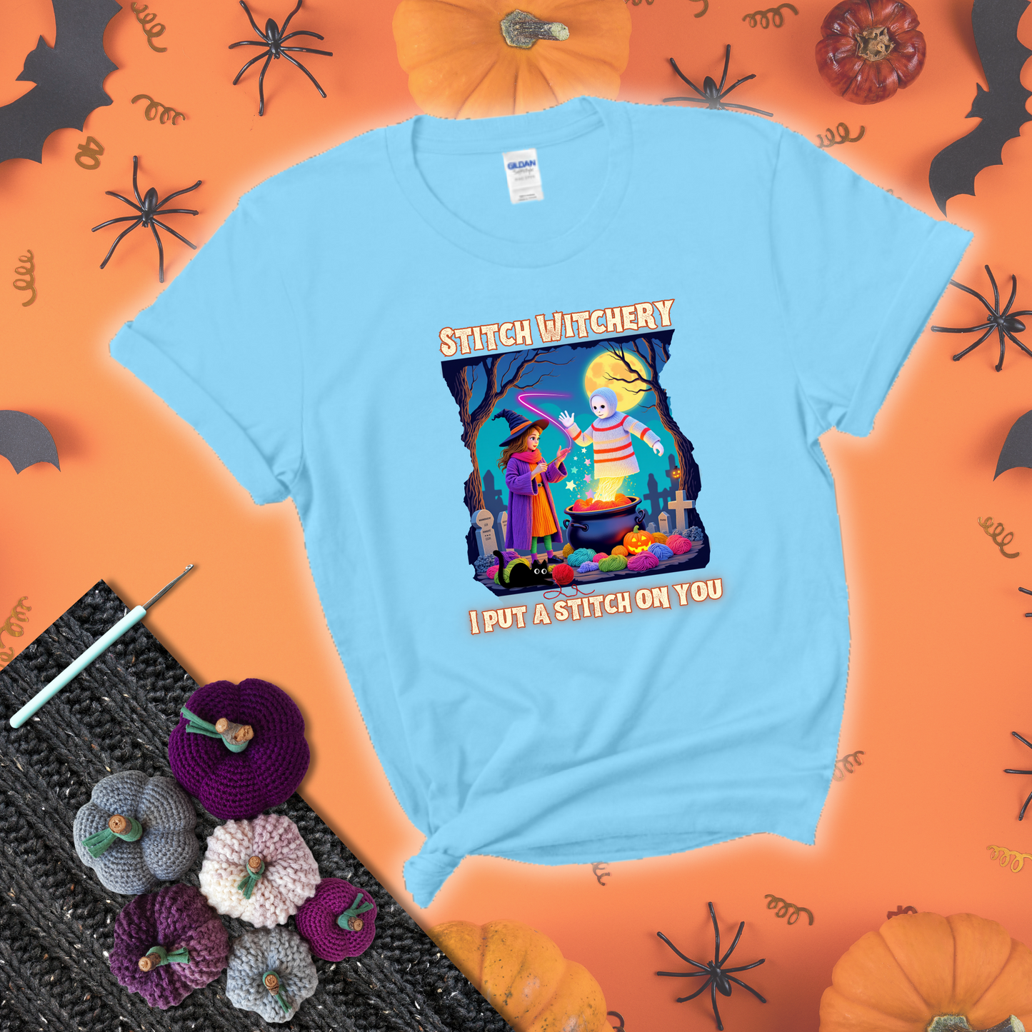 A Halloween scene with a young witch casting a yarn spell from a cauldron onto a floating crochet-ghost figure, under the phrase “I Put a Stitch on You” showing a light blue tee with a festive Halloween background