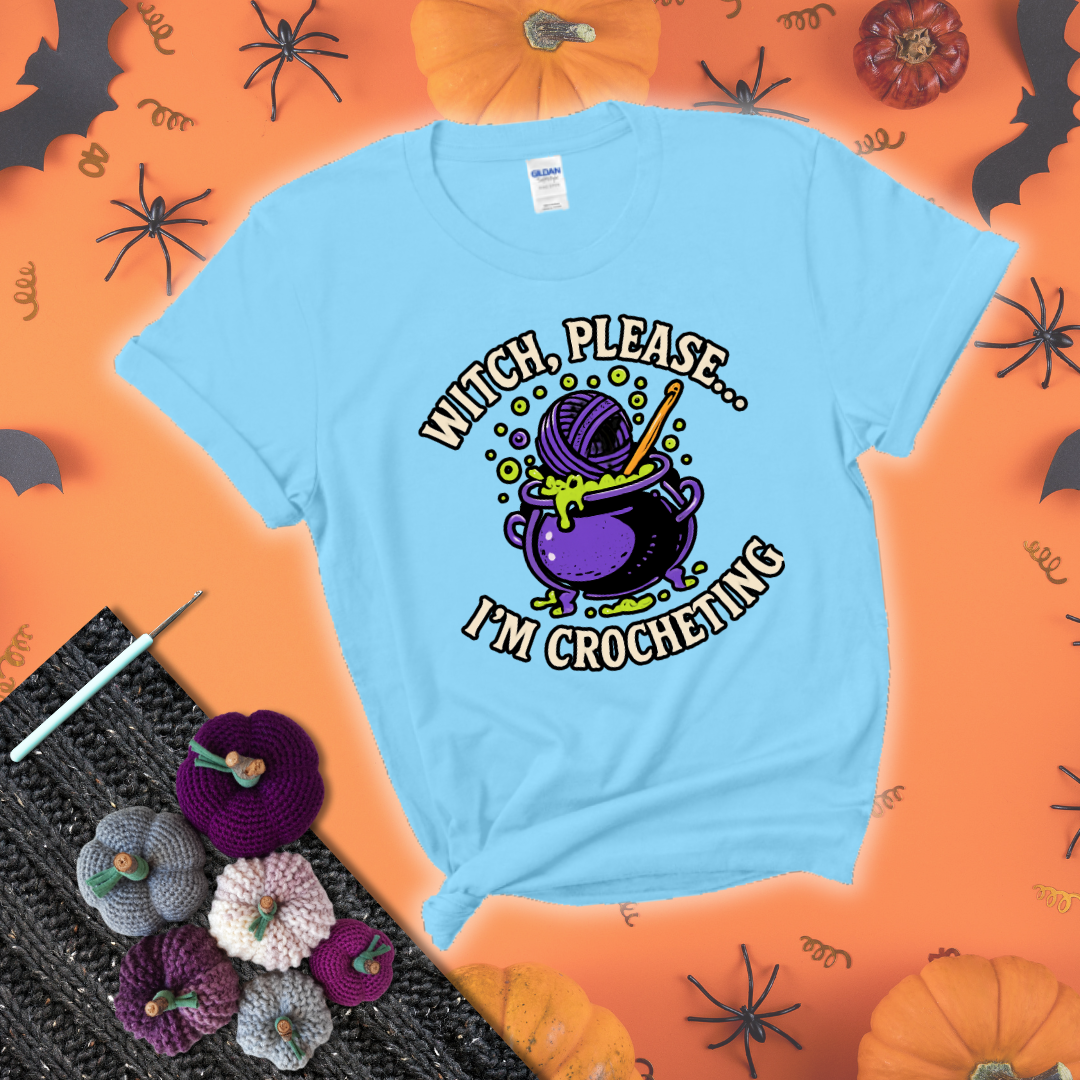 Put a spell on your stash Design reads 'Witch, Please… I’m Crocheting,' perfect crochet gift for yarn lovers showing a light blue tee with a festive Halloween background