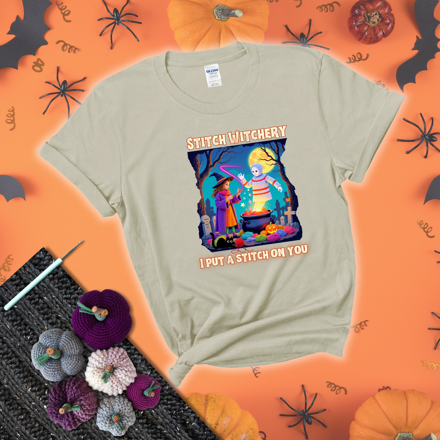 A Halloween scene with a young witch casting a yarn spell from a cauldron onto a floating crochet-ghost figure, under the phrase “I Put a Stitch on You” showing a beige tee with a festive Halloween background