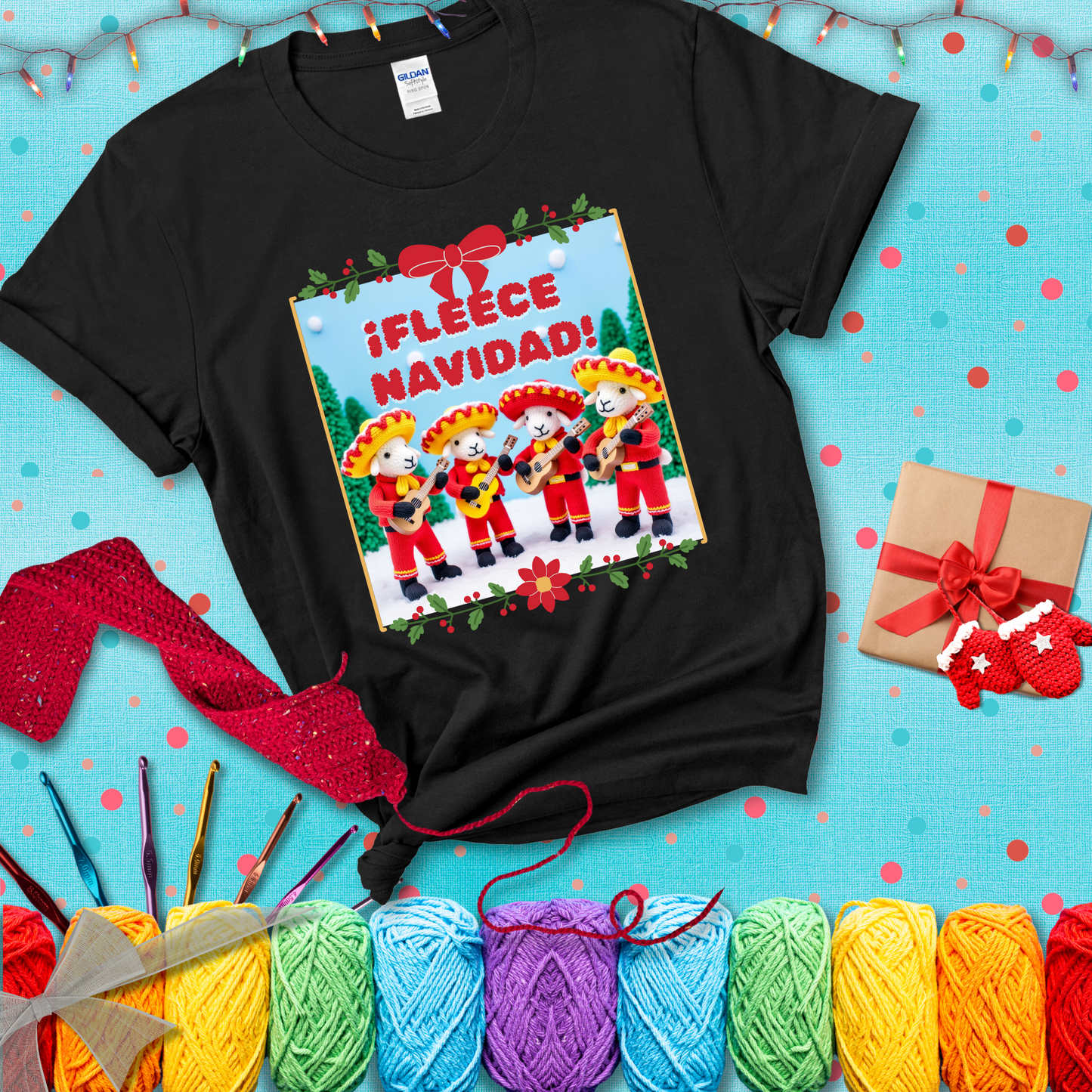 Four crocheted sheep dressed in red mariachi outfits with guitars, standing in a snowy scene under the phrase “¡Fleece Navidad!” showing a black tee with a festive Christmas background
