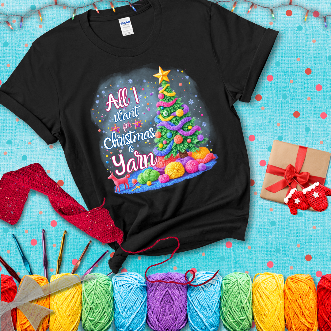 Bright Christmas tree decorated with yarn garlands, balls of yarn underneath, and the text “All I Want for Christmas is Yarn” in festive fonts, showing a black tee with a festive Christmas background