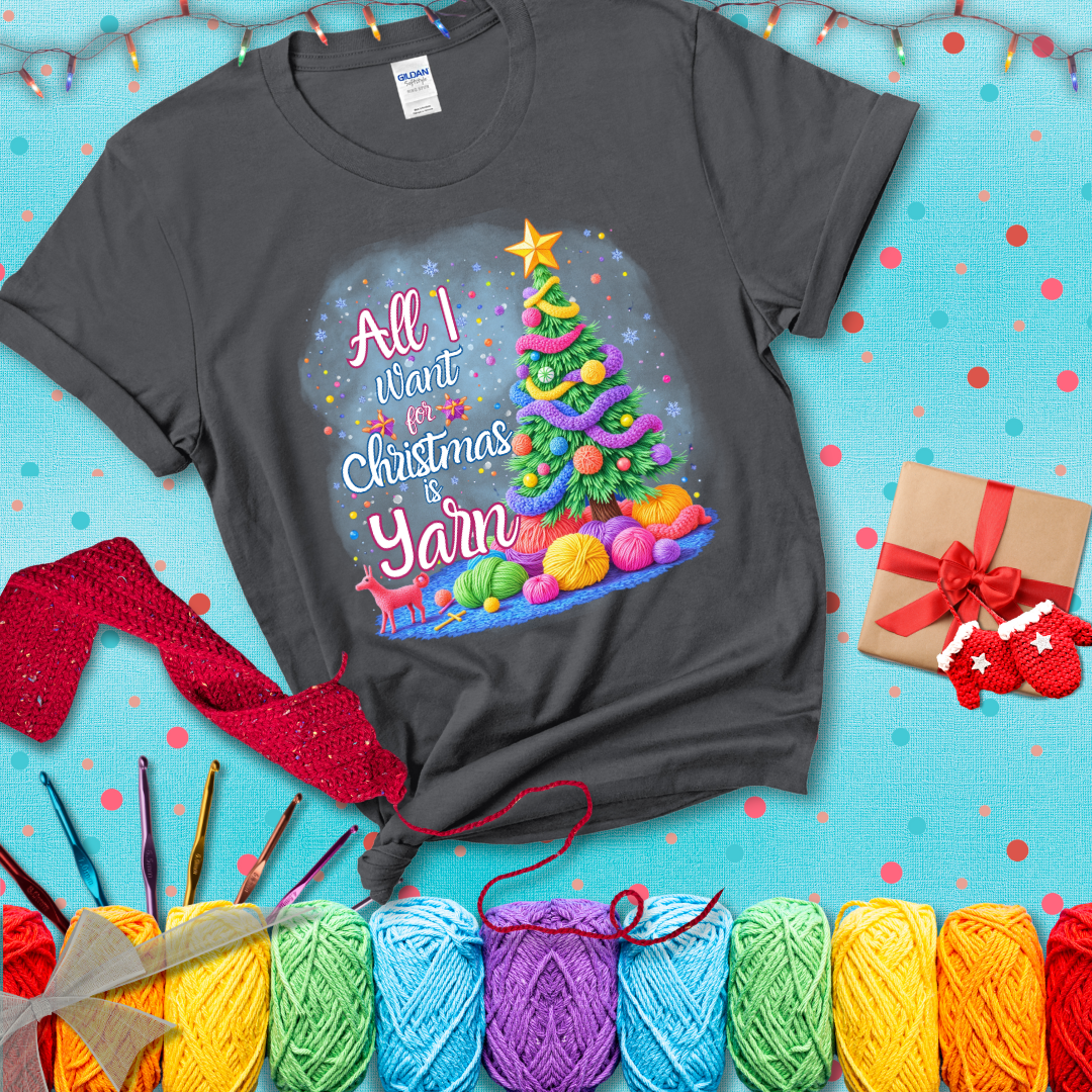 Bright Christmas tree decorated with yarn garlands, balls of yarn underneath, and the text “All I Want for Christmas is Yarn” in festive fonts, showing a dark grey tee with a festive Christmas background