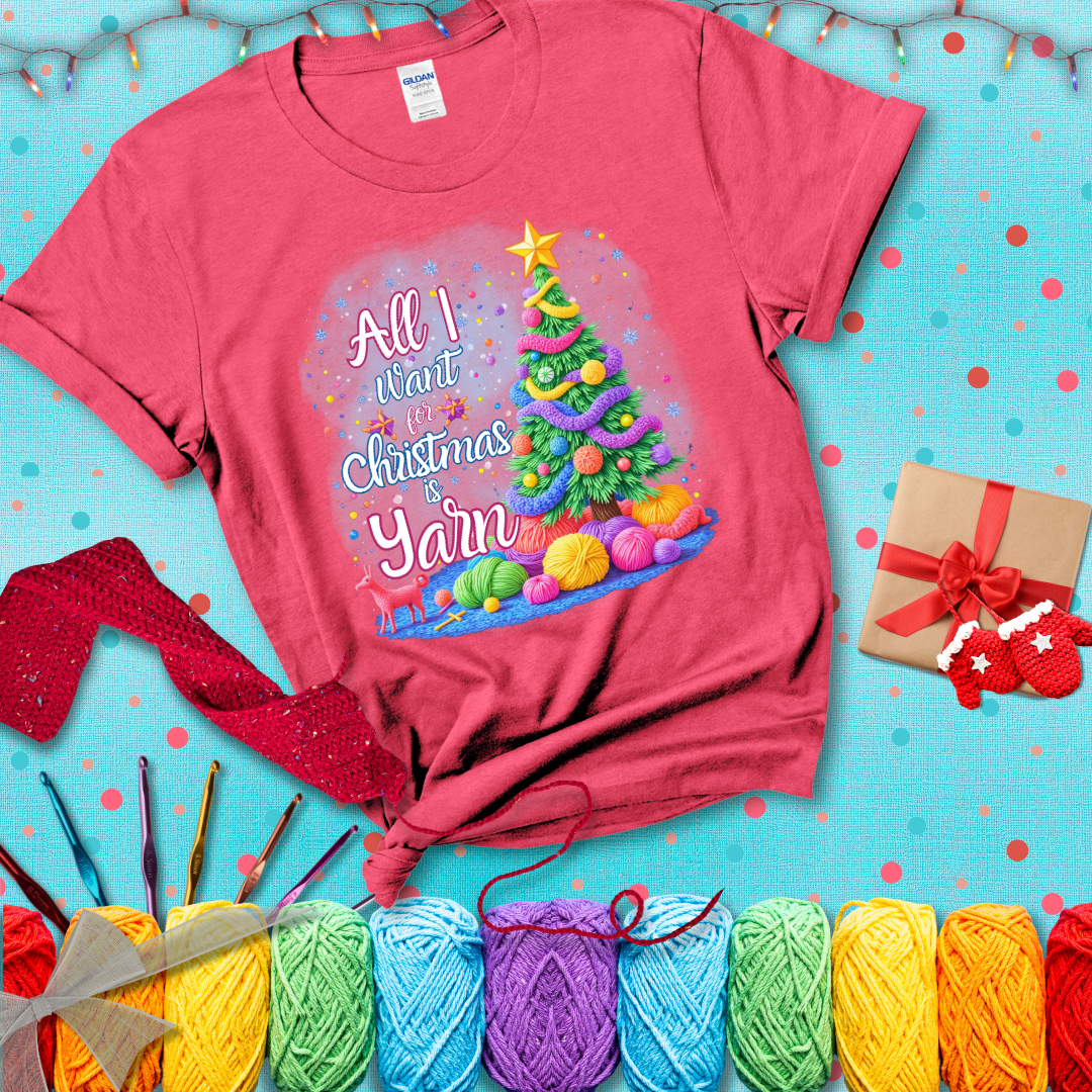 Bright Christmas tree decorated with yarn garlands, balls of yarn underneath, and the text “All I Want for Christmas is Yarn” in festive fonts, showing a light red tee with a festive Christmas background