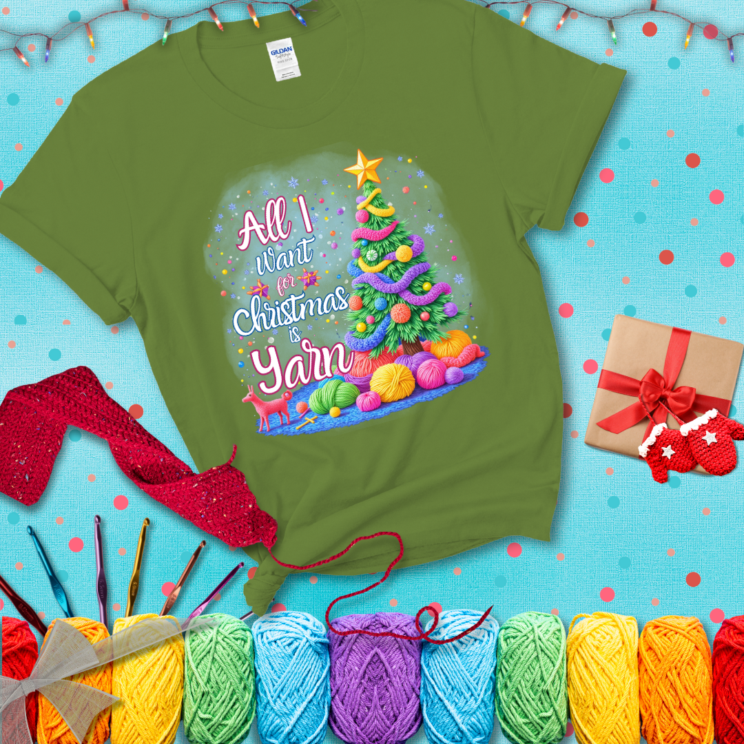 Bright Christmas tree decorated with yarn garlands, balls of yarn underneath, and the text “All I Want for Christmas is Yarn” in festive fonts, showing a bright green tee with a festive Christmas background