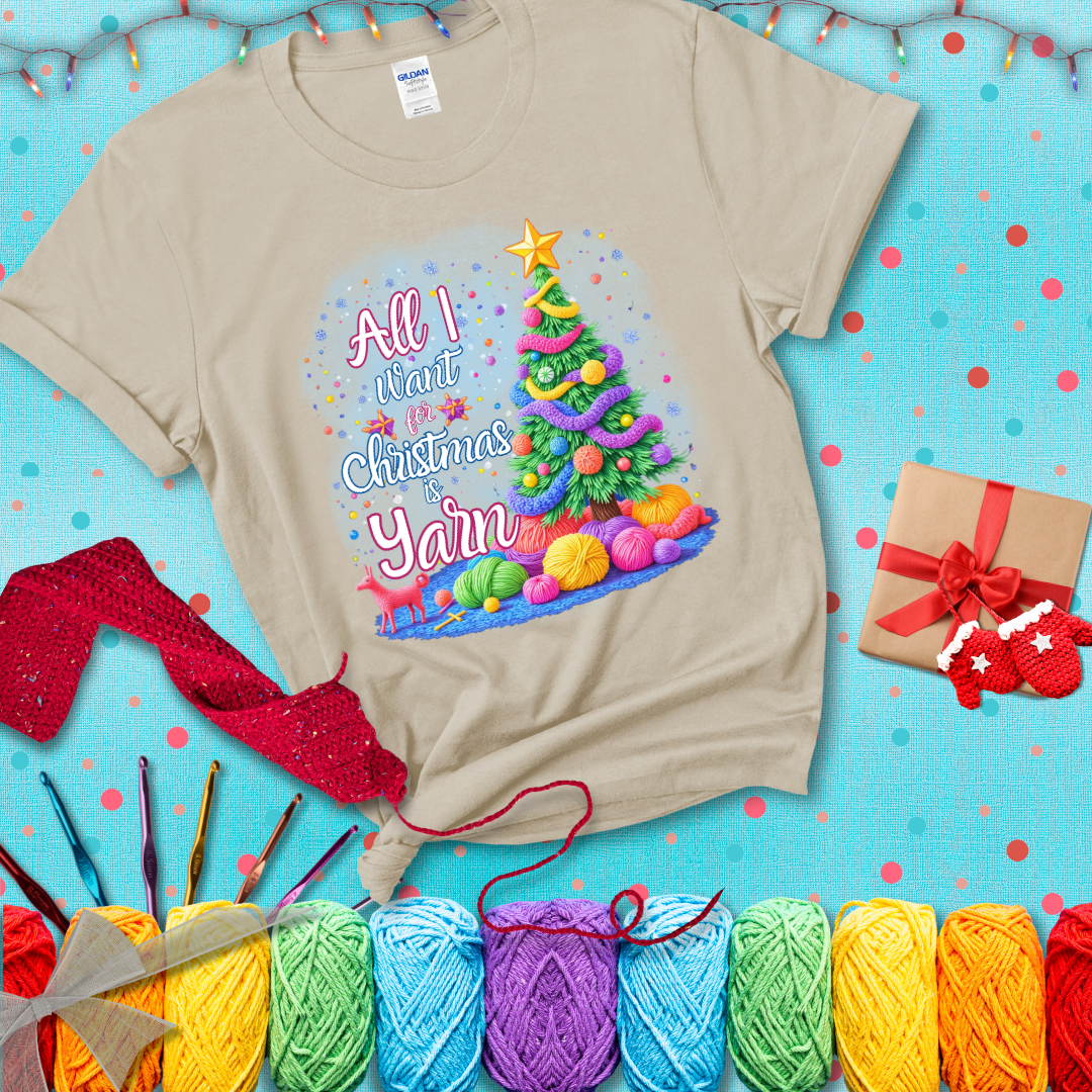 Bright Christmas tree decorated with yarn garlands, balls of yarn underneath, and the text “All I Want for Christmas is Yarn” in festive fonts, showing a beige tee with a festive Christmas background