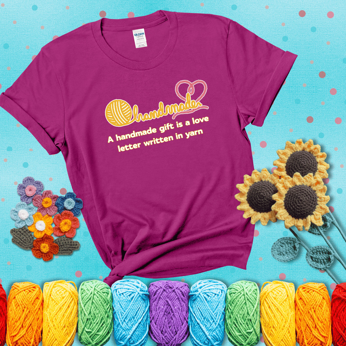 Soft script-style design with heart detail. Text reads: “A Handmade Gift Is a Love Letter Written in Yarn.” A sweet and sentimental shirt for crocheters who craft from the heart, showing a magenta tee with a teal sunflower background