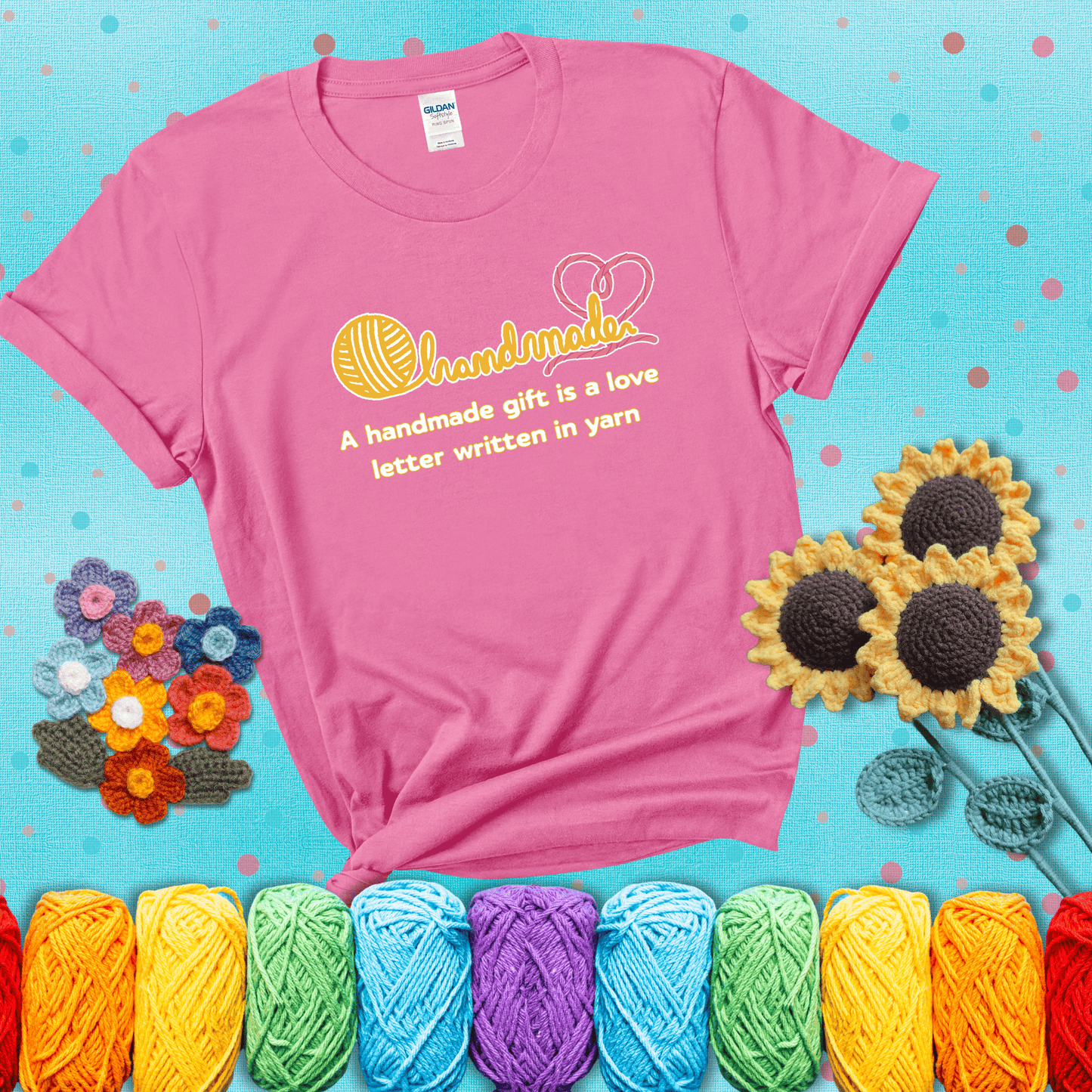 Soft script-style design with heart detail. Text reads: “A Handmade Gift Is a Love Letter Written in Yarn.” A sweet and sentimental shirt for crocheters who craft from the heart, showing a pink tee with a teal sunflower background