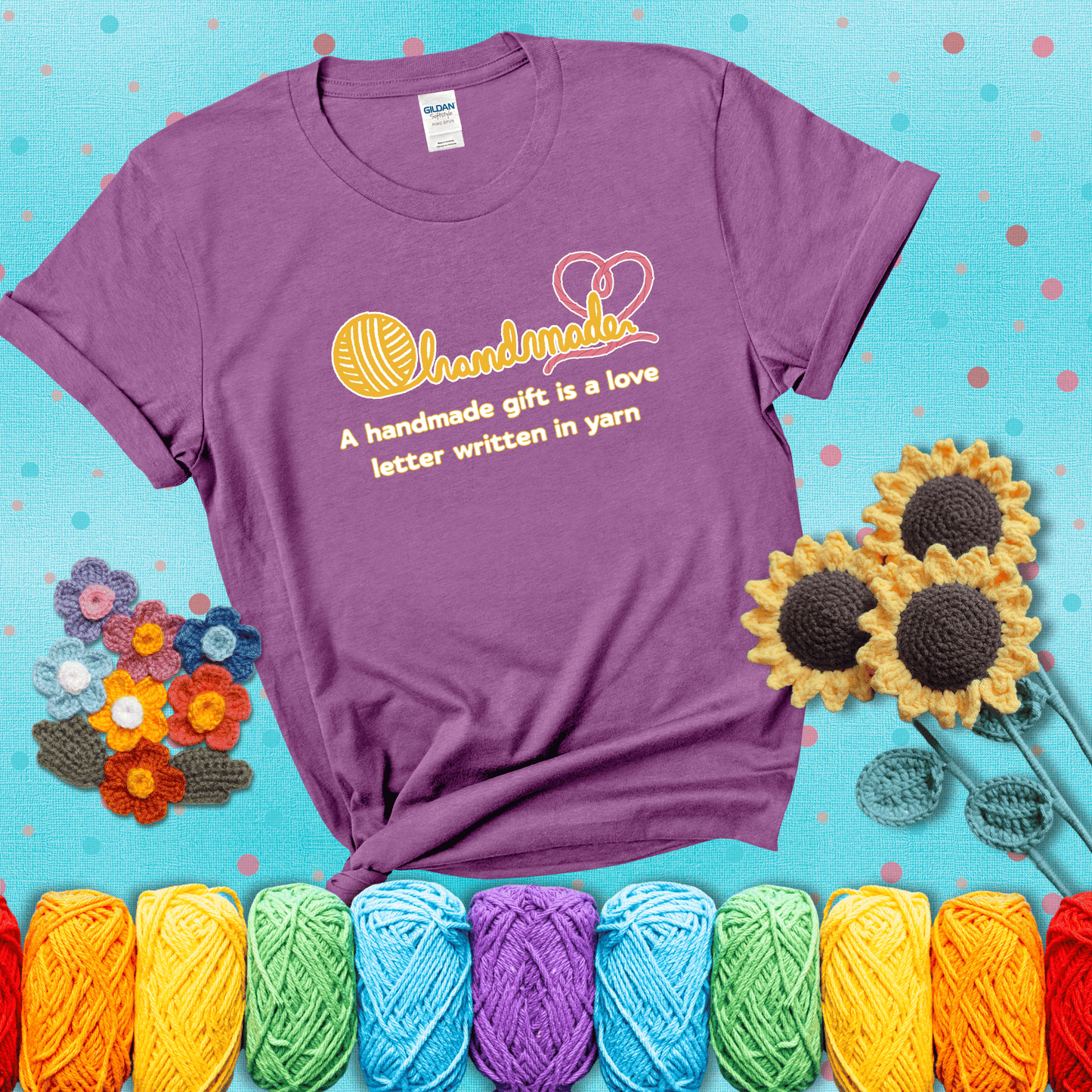 Soft script-style design with heart detail. Text reads: “A Handmade Gift Is a Love Letter Written in Yarn.” A sweet and sentimental shirt for crocheters who craft from the heart, showing a light purple tee with a teal sunflower background