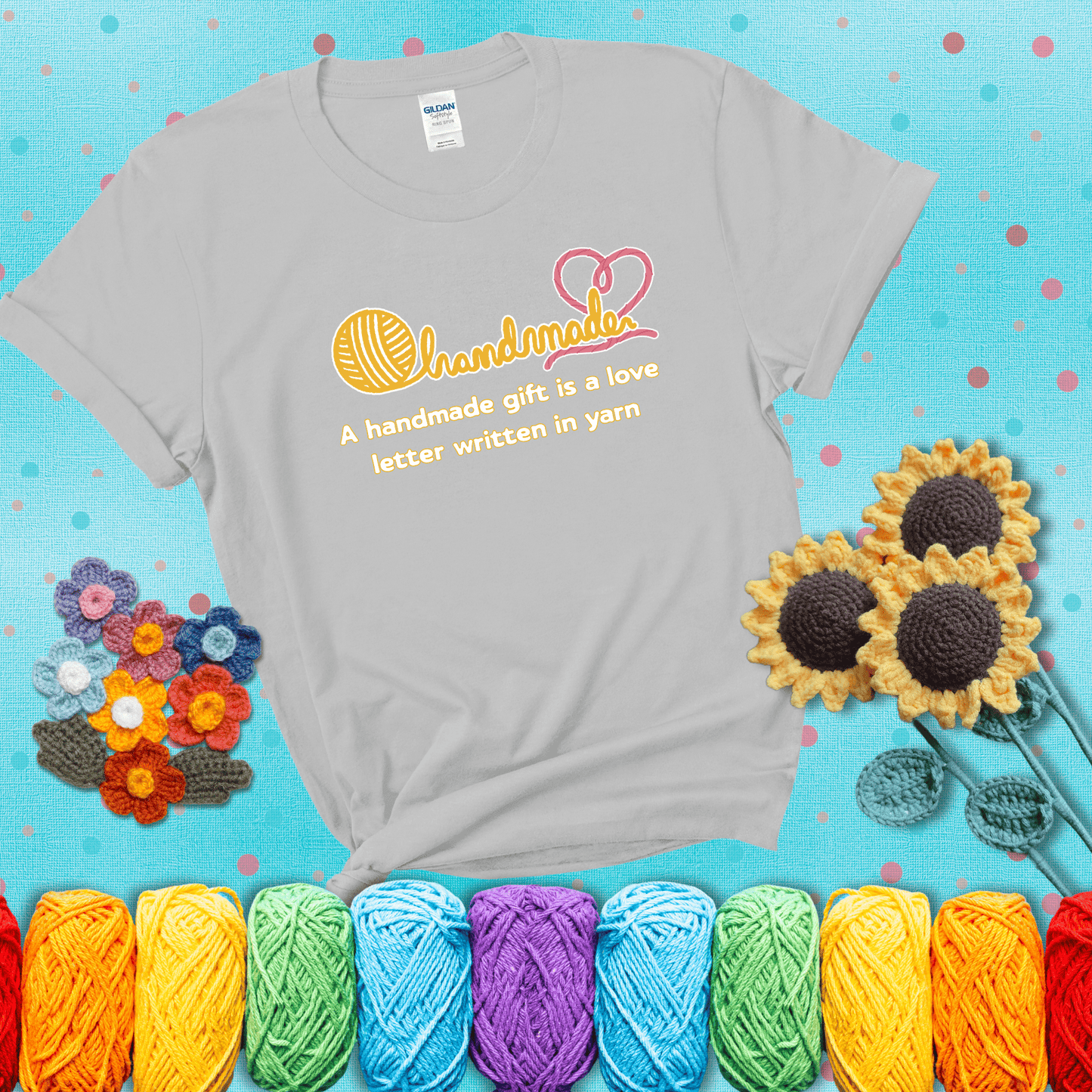 Soft script-style design with heart detail. Text reads: “A Handmade Gift Is a Love Letter Written in Yarn.” A sweet and sentimental shirt for crocheters who craft from the heart, showing a light grey tee with a teal sunflower background