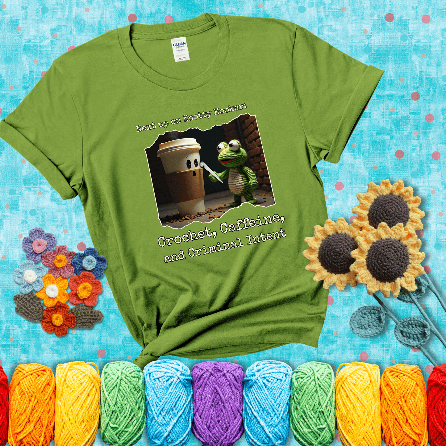 A crocheted frog holding a crochet hook confronts a surprised coffee cup in a dim alleyway with text: "Next up on Knotty Hooker: Crochet, Caffeine, and Criminal Intent," showing a bright green tee with a teal sunflower background