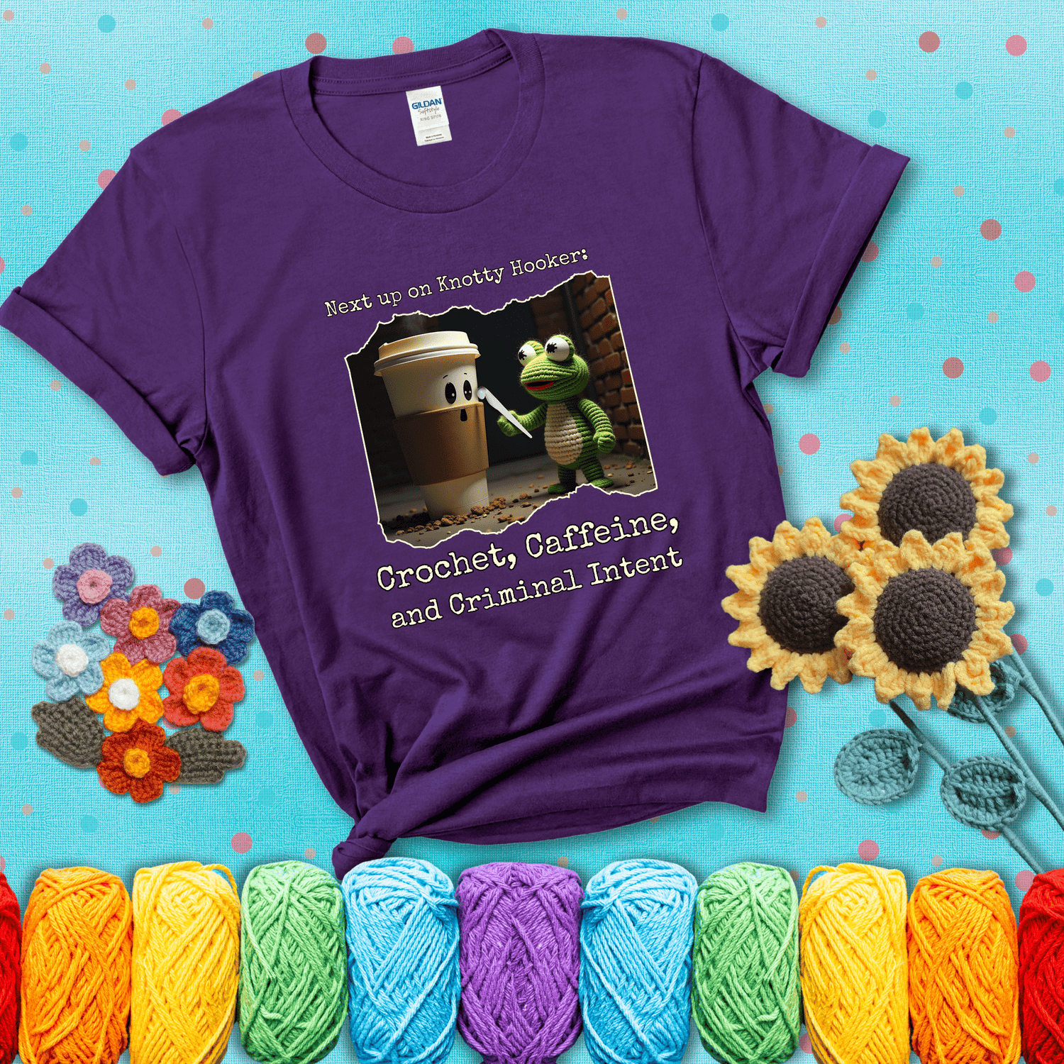 A crocheted frog holding a crochet hook confronts a surprised coffee cup in a dim alleyway with text: "Next up on Knotty Hooker: Crochet, Caffeine, and Criminal Intent," showing a purple tee with a teal sunflower background
