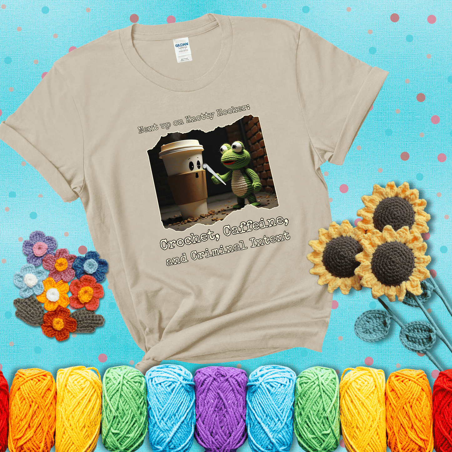 A crocheted frog holding a crochet hook confronts a surprised coffee cup in a dim alleyway with text: "Next up on Knotty Hooker: Crochet, Caffeine, and Criminal Intent," showing a beige tee with a teal sunflower background