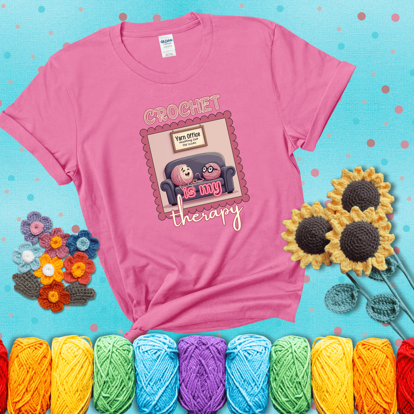 Simple text design with soothing yarn elements. Text reads: “Crochet is My Therapy.” A calming tee for fiber lovers who find healing in every stitch; showing a pink tee with a teal sunflower background