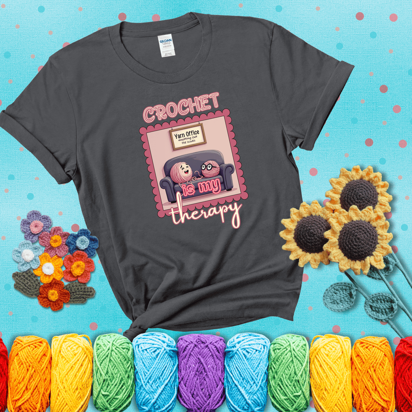 Simple text design with soothing yarn elements. Text reads: “Crochet is My Therapy.” A calming tee for fiber lovers who find healing in every stitch; showing a dark grey tee with a teal sunflower background