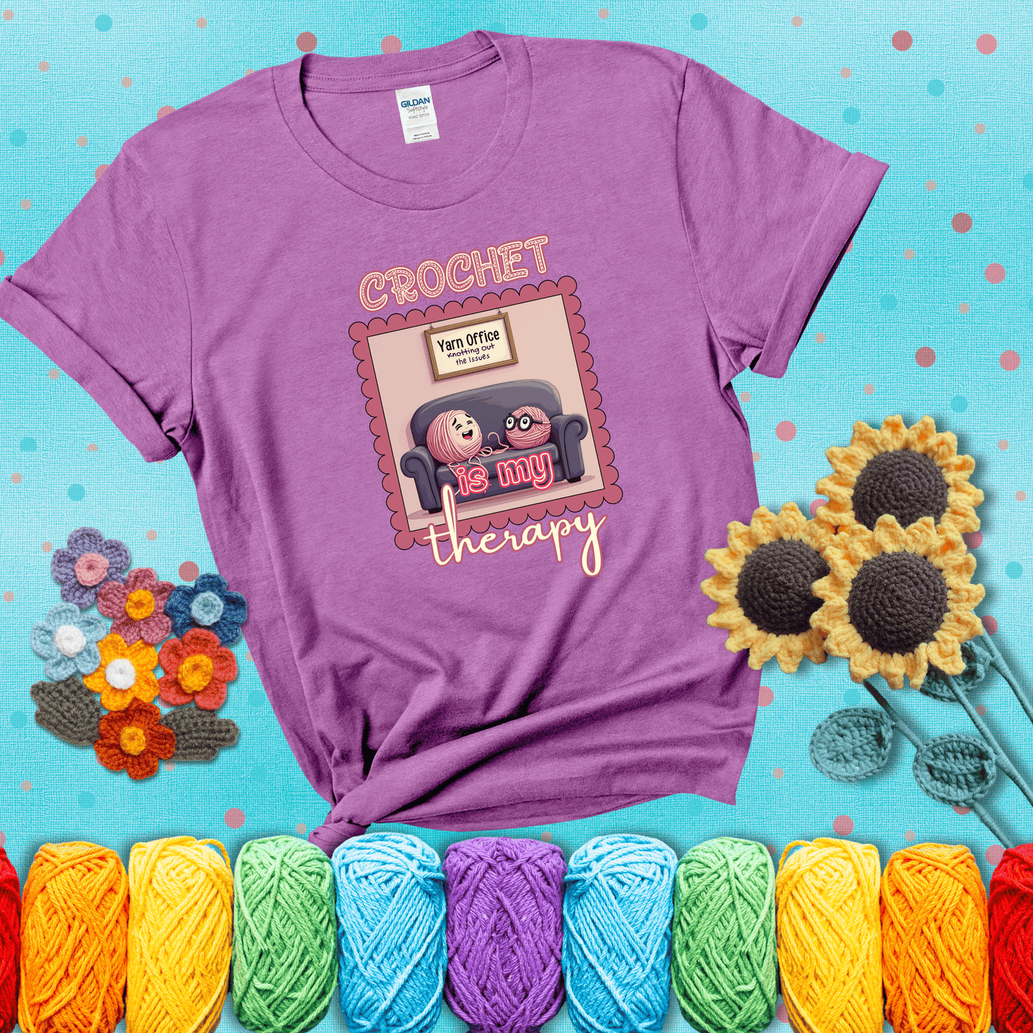 Simple text design with soothing yarn elements. Text reads: “Crochet is My Therapy.” A calming tee for fiber lovers who find healing in every stitch; showing a light purple tee with a teal sunflower background