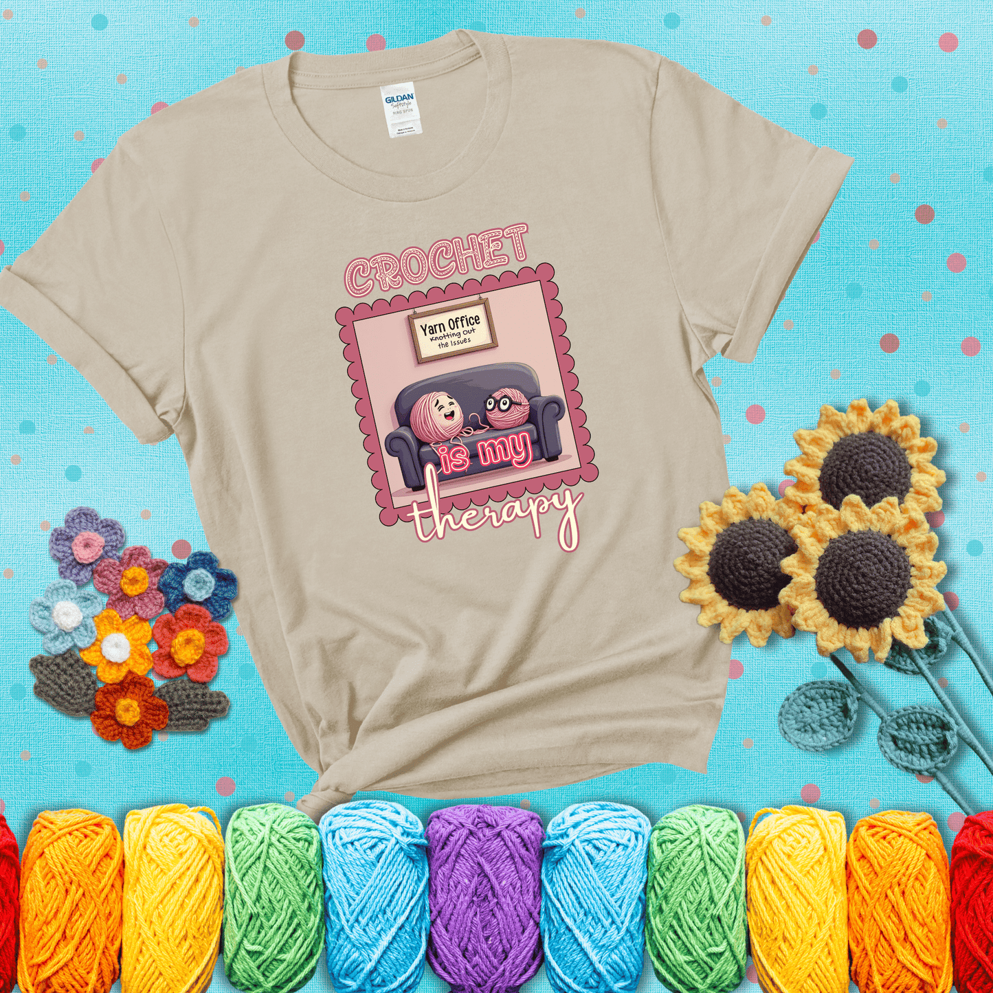 Simple text design with soothing yarn elements. Text reads: “Crochet is My Therapy.” A calming tee for fiber lovers who find healing in every stitch; showing a beige tee with a teal sunflower background