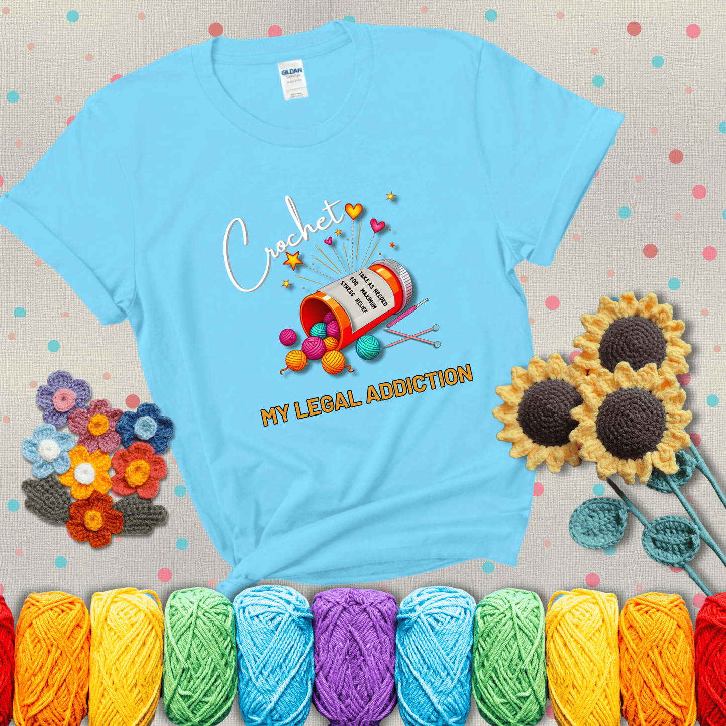 Orange prescription bottle spilling colorful yarn balls with text "Crochet – My Legal Addiction" and "Take as needed for maximum stress relief" showing a light blue tee with grey sunflower background