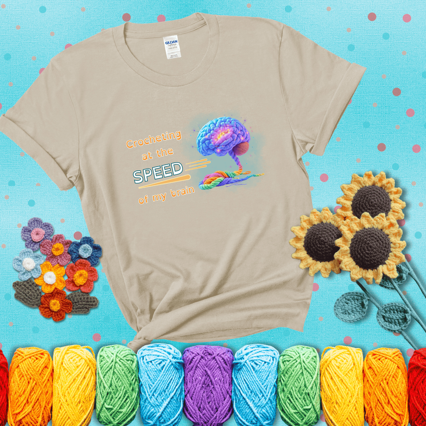 A glowing rainbow brain unravels into colorful yarn with the phrase “Crocheting at the speed of my brain;" showing a beige tee with a teal sunflower background