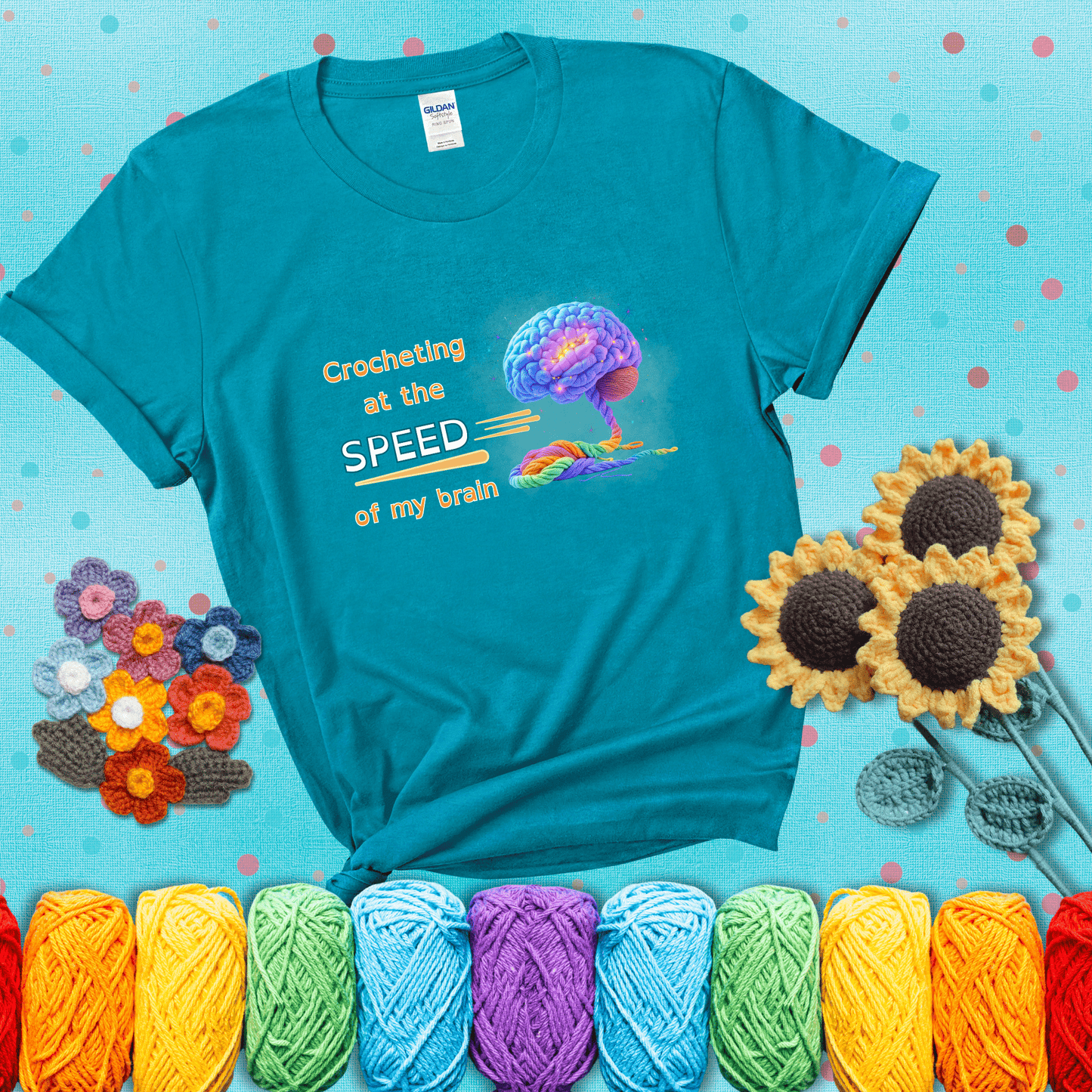 A glowing rainbow brain unravels into colorful yarn with the phrase “Crocheting at the speed of my brain;" showing a blue-green tee with a teal sunflower background