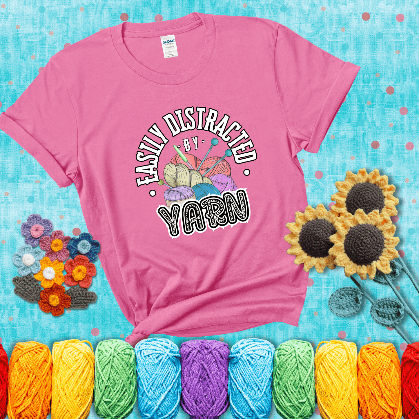 If yarn steals your focus every Design reads 'Easily Distracted By Yarn', perfect crochet gift for yarn lovers; showing a pink tee with a teal sunflower background