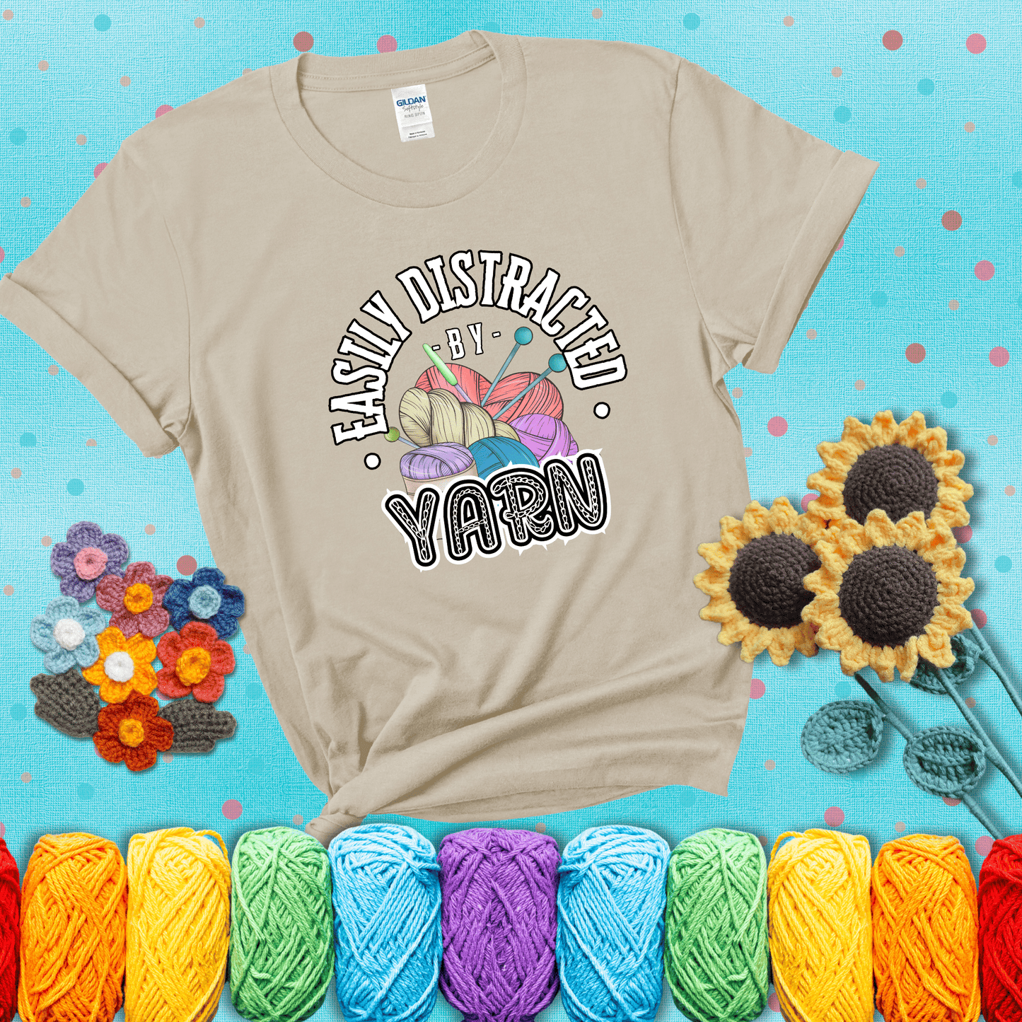 If yarn steals your focus every Design reads 'Easily Distracted By Yarn', perfect crochet gift for yarn lovers; showing a beige tee with a teal sunflower background