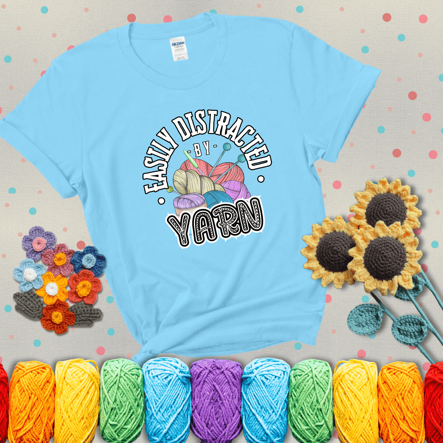 If yarn steals your focus every Design reads 'Easily Distracted By Yarn', perfect crochet gift for yarn lovers; showing a light blue tee with grey sunflower background
