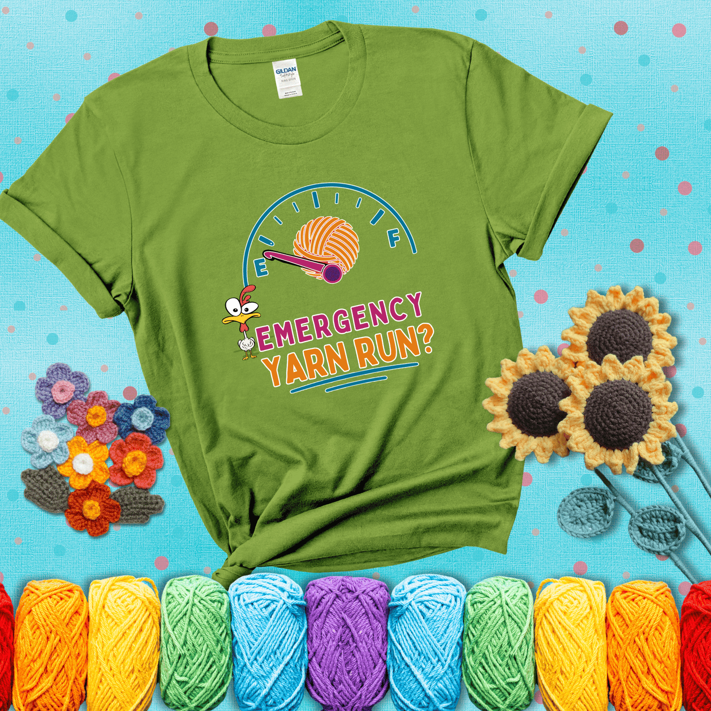 A fuel gauge with a ball of yarn as the needle pointing to empty, a frantic chicken, and the text “Emergency Yarn Run?” showing a bright green tee with a teal sunflower background
