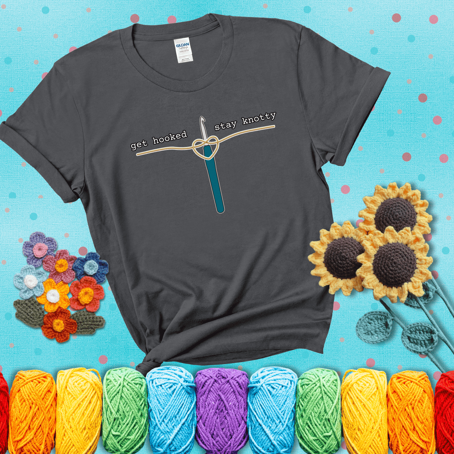 Hooked on yarn? Same Design reads 'Get Hooked, Stay Knotty' , perfect crochet gift for yarn lovers, showing a dark grey tee with a teal sunflower background