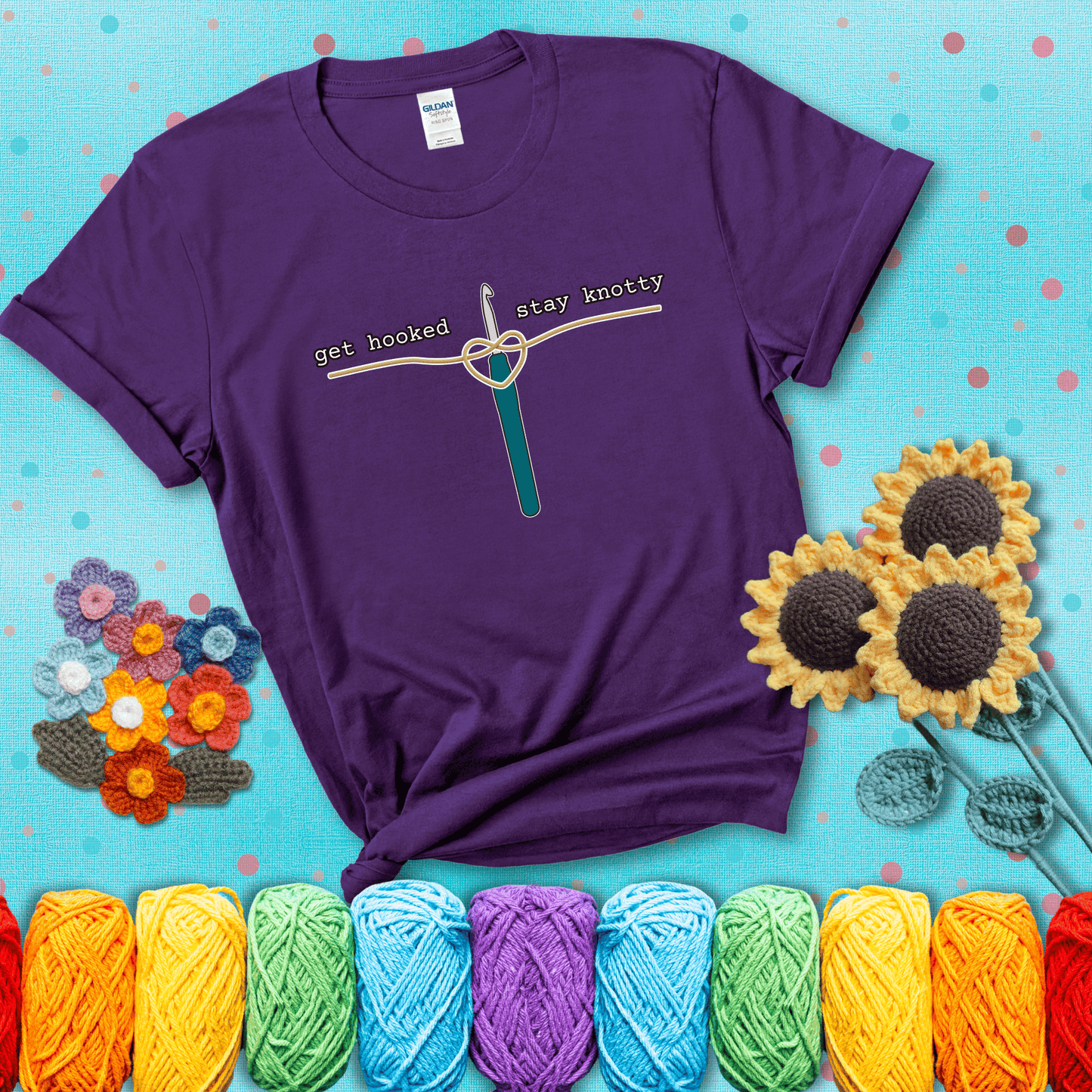 Hooked on yarn? Same Design reads 'Get Hooked, Stay Knotty' , perfect crochet gift for yarn lovers, showing a purple tee with a teal sunflower background