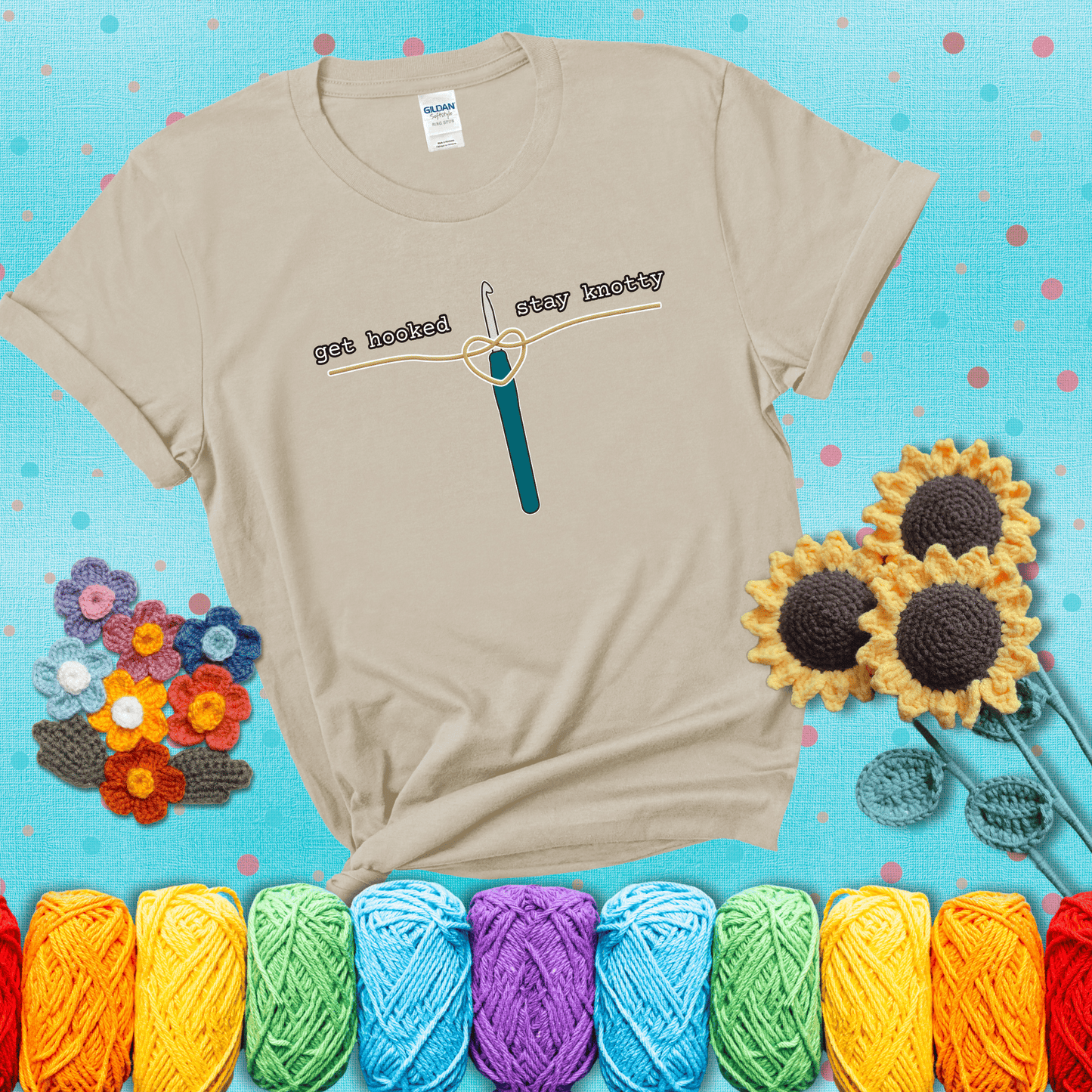 Hooked on yarn? Same Design reads 'Get Hooked, Stay Knotty' , perfect crochet gift for yarn lovers, showing a beige tee with a teal sunflower background