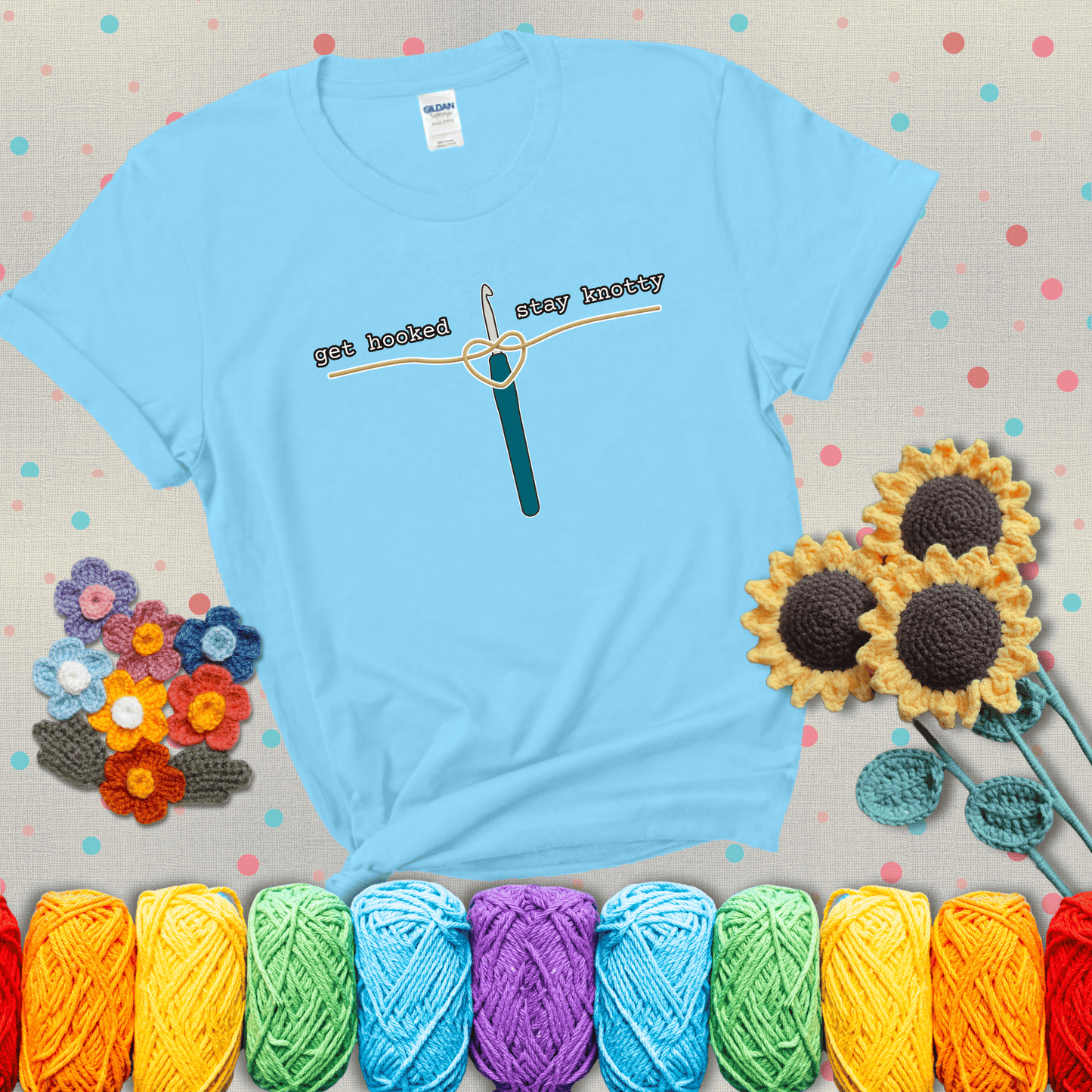 Hooked on yarn? Same Design reads 'Get Hooked, Stay Knotty' , perfect crochet gift for yarn lovers, showing a light blue tee with grey sunflower background