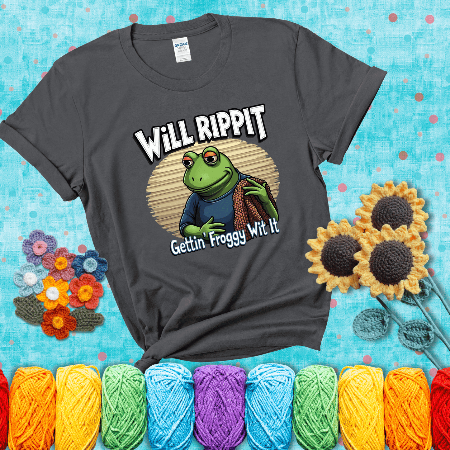Cool frog with sunglasses, surrounded by yarn and hooks. Text reads: “Gettin’ Froggy Wit It.” A hip and humorous crochet tee for yarn lovers with rhythm, showing a dark grey tee with a teal sunflower background