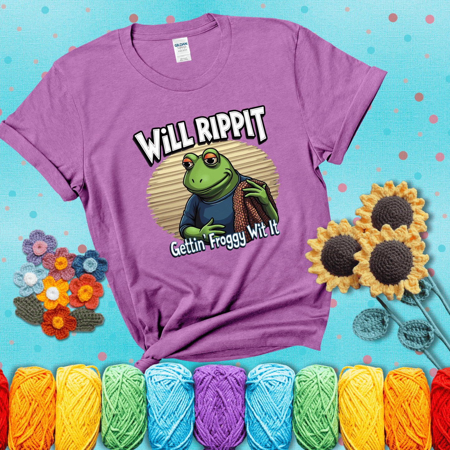 Cool frog with sunglasses, surrounded by yarn and hooks. Text reads: “Gettin’ Froggy Wit It.” A hip and humorous crochet tee for yarn lovers with rhythm, showing a light purple tee with a teal sunflower background