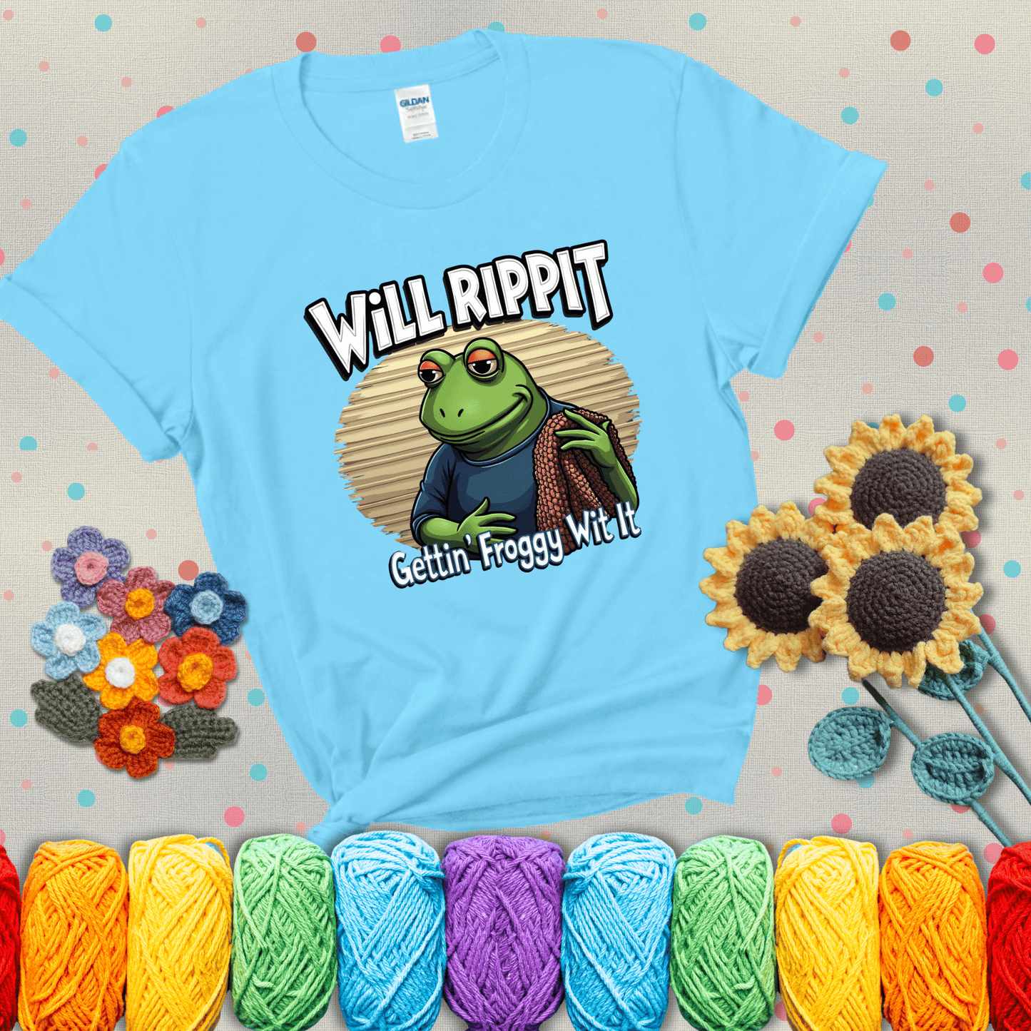 Cool frog with sunglasses, surrounded by yarn and hooks. Text reads: “Gettin’ Froggy Wit It.” A hip and humorous crochet tee for yarn lovers with rhythm, showing a light blue tee with grey sunflower background