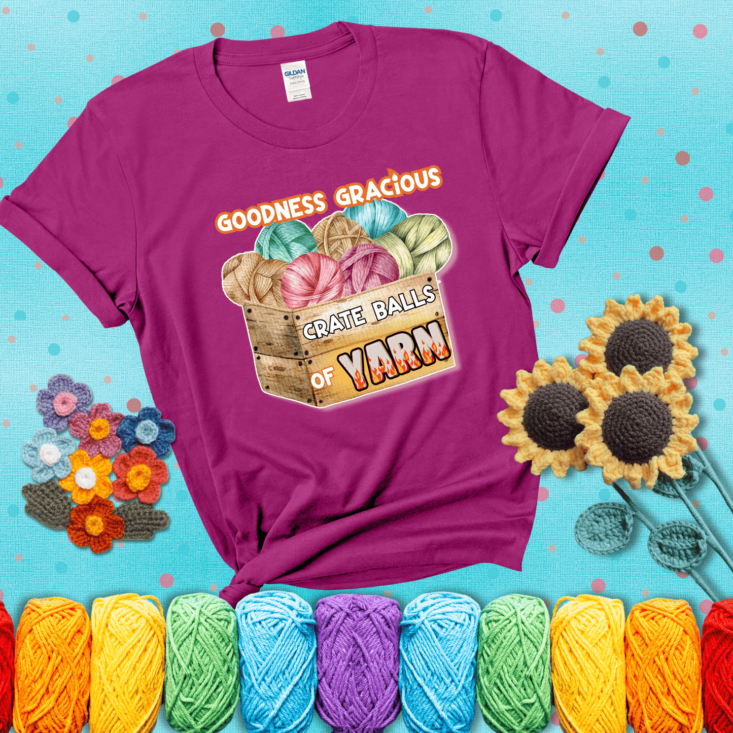 Wooden crate filled with colorful yarn balls and bold text “Goodness Gracious, Crate Balls of Yarn” with flame effects, a funny gift for crocheters showing a magenta tee with a teal sunflower background