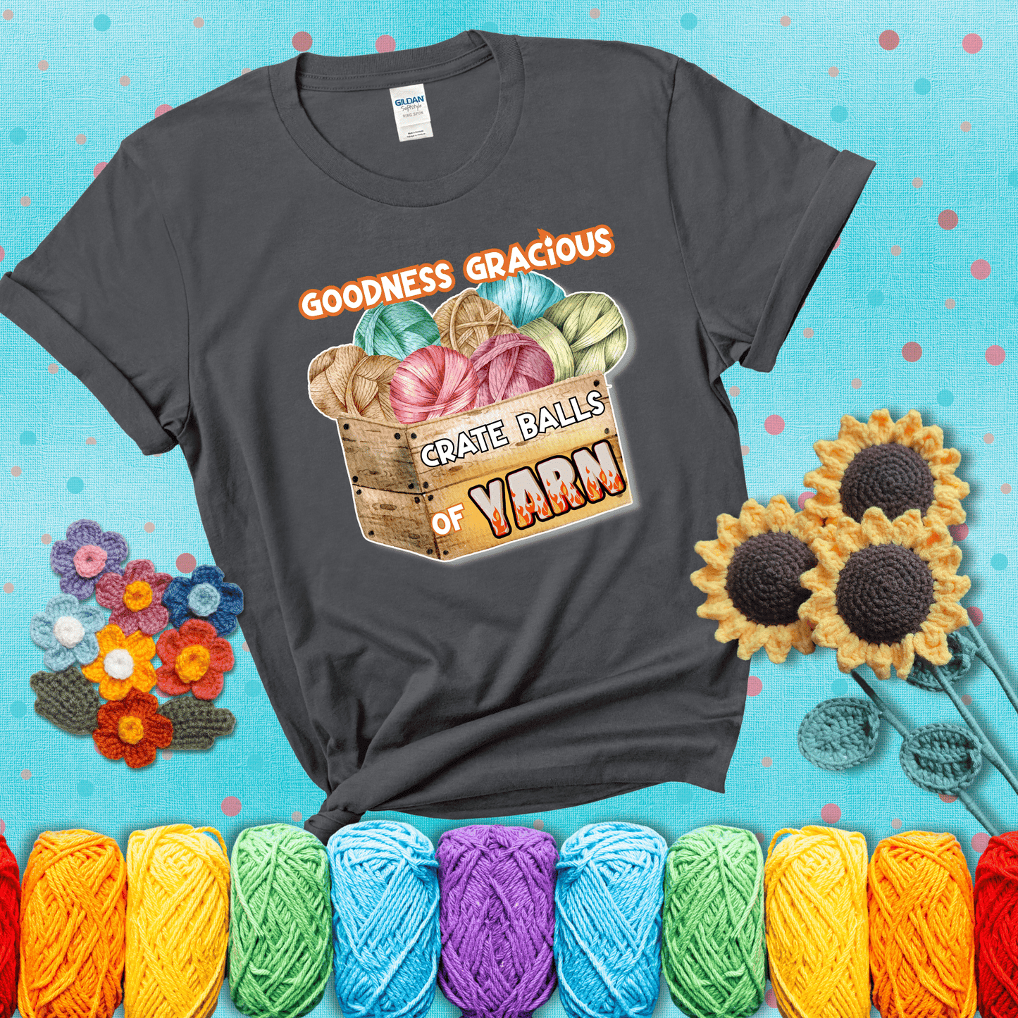 Wooden crate filled with colorful yarn balls and bold text “Goodness Gracious, Crate Balls of Yarn” with flame effects, a funny gift for crocheters showing a dark grey tee with a teal sunflower background