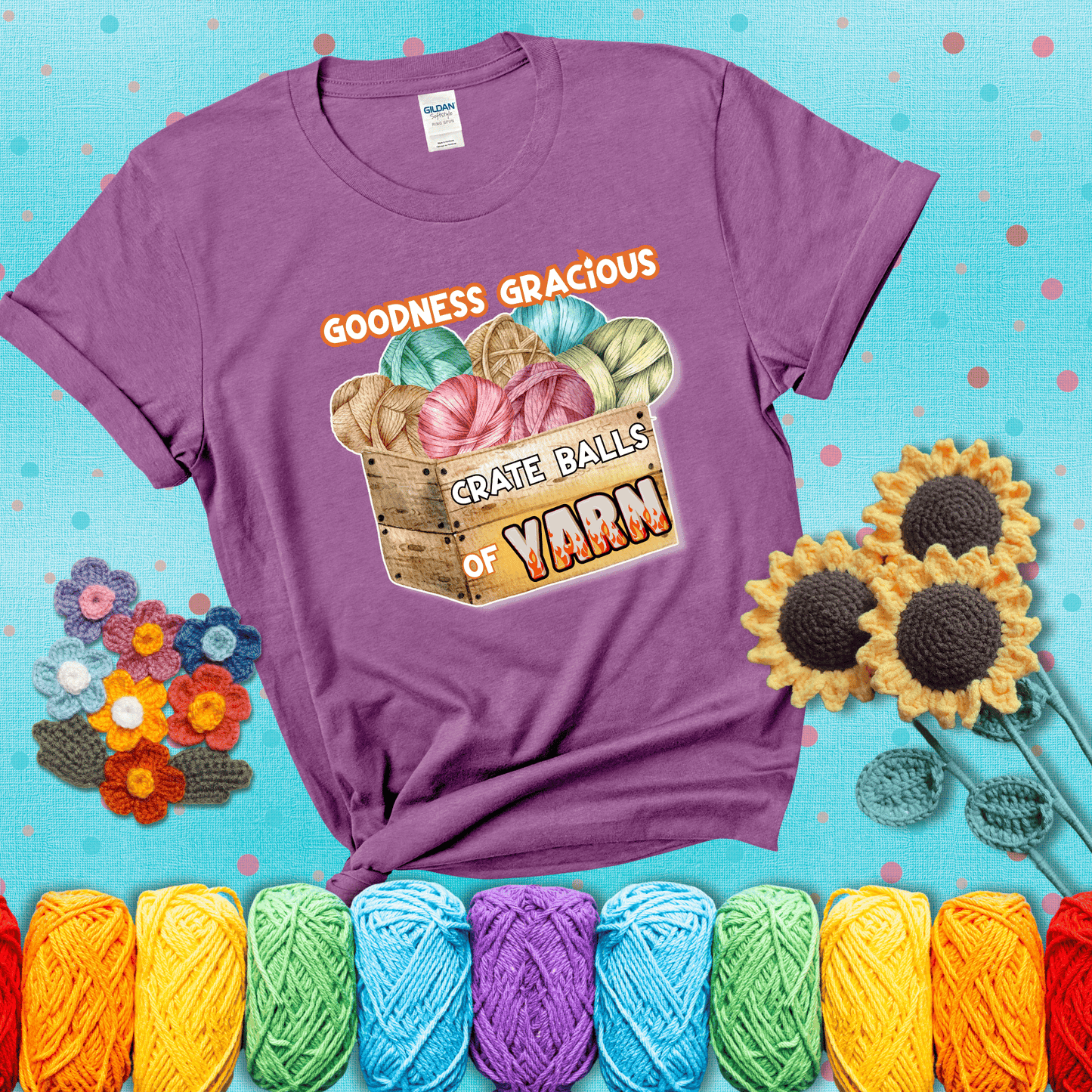Wooden crate filled with colorful yarn balls and bold text “Goodness Gracious, Crate Balls of Yarn” with flame effects, a funny gift for crocheters showing a light purple tee with a teal sunflower background