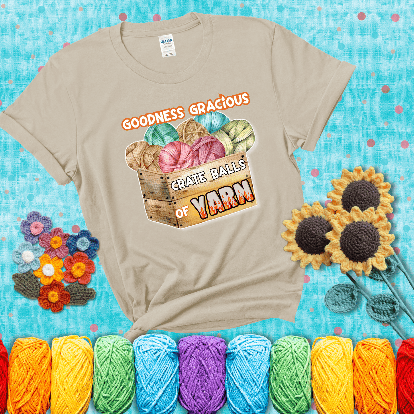 Wooden crate filled with colorful yarn balls and bold text “Goodness Gracious, Crate Balls of Yarn” with flame effects, a funny gift for crocheters showing a beige tee with a teal sunflower background