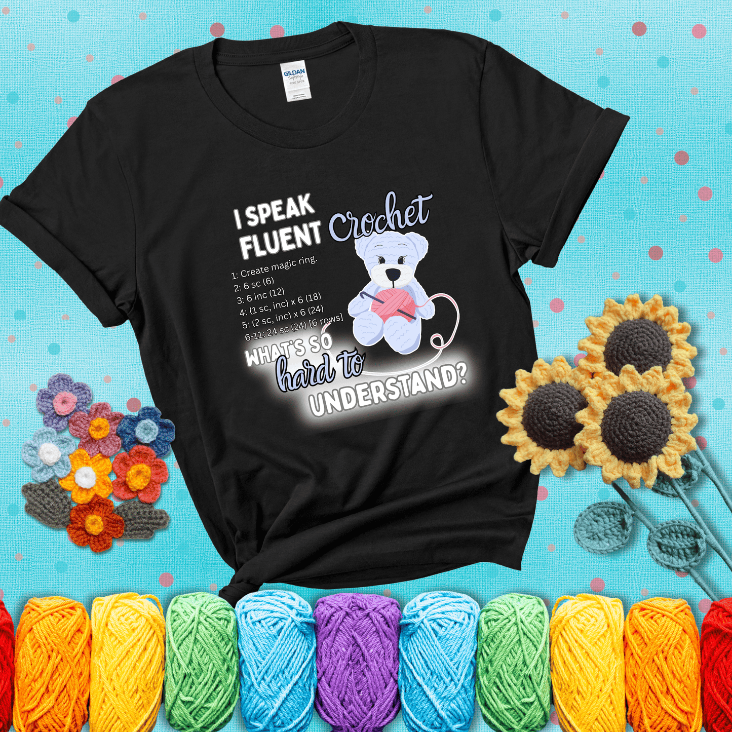 A cute crochet bear holding a yarn ball, surrounded by a short crochet pattern. The phrase reads “I Speak Fluent Crochet – What’s so hard to understand?” showing a black tee with a teal sunflower background