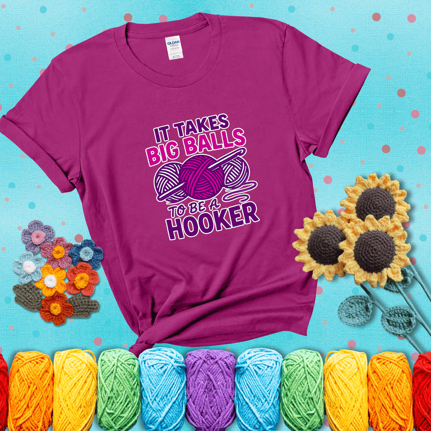Bigger yarn, bolder energy Design reads 'It Takes Big Balls To Be A Hooker' , perfect crochet gift for yarn lovers showing a magenta tee with a teal sunflower background